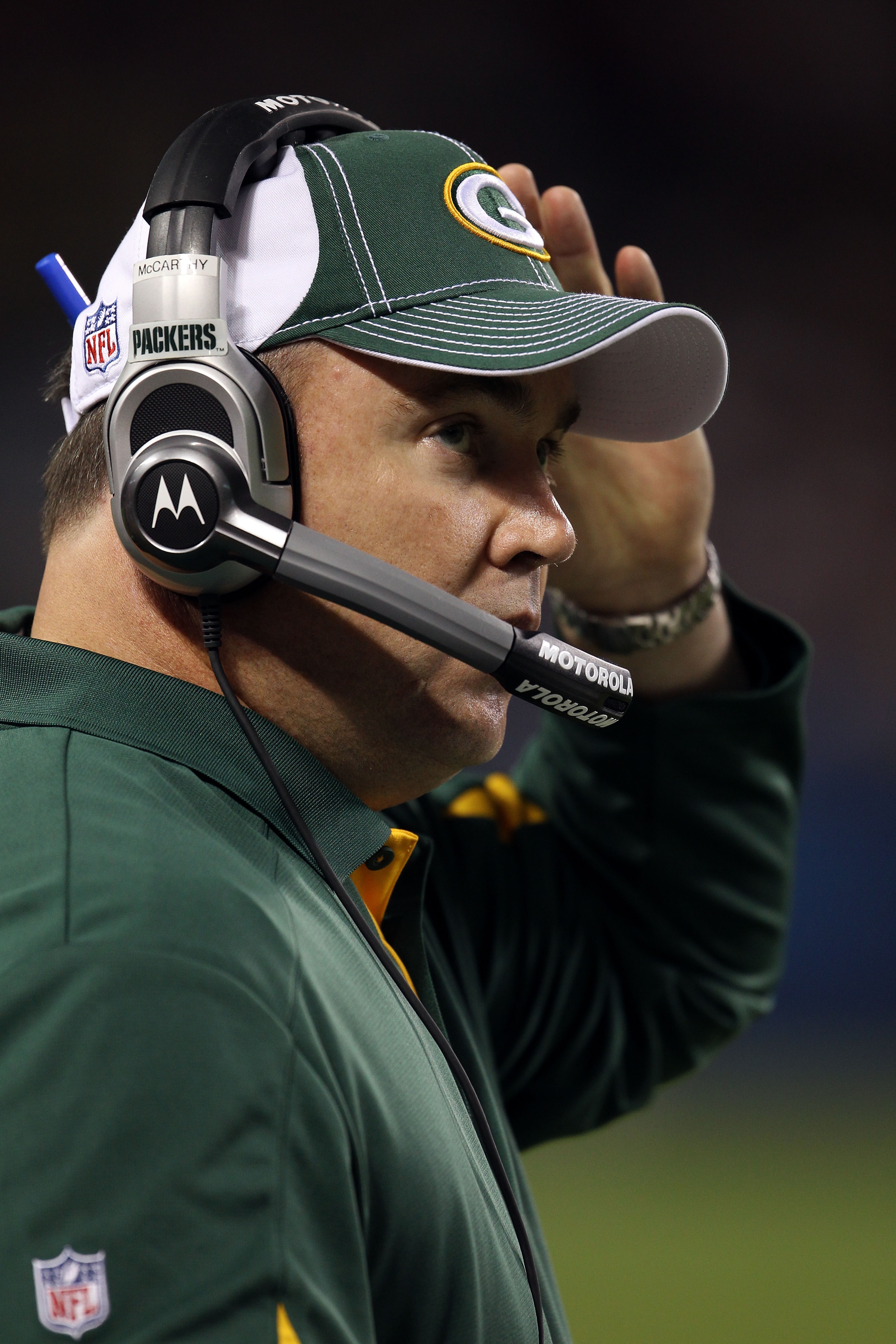 CHICAGO - SEPTEMBER 27:  Head coach Mike McCarthy of the Green Bay Packers talks into his headset against the Chicago Bears at Soldier Field on September 27, 2010 in Chicago, Illinois.  (Photo by Jonathan Daniel/Getty Images)