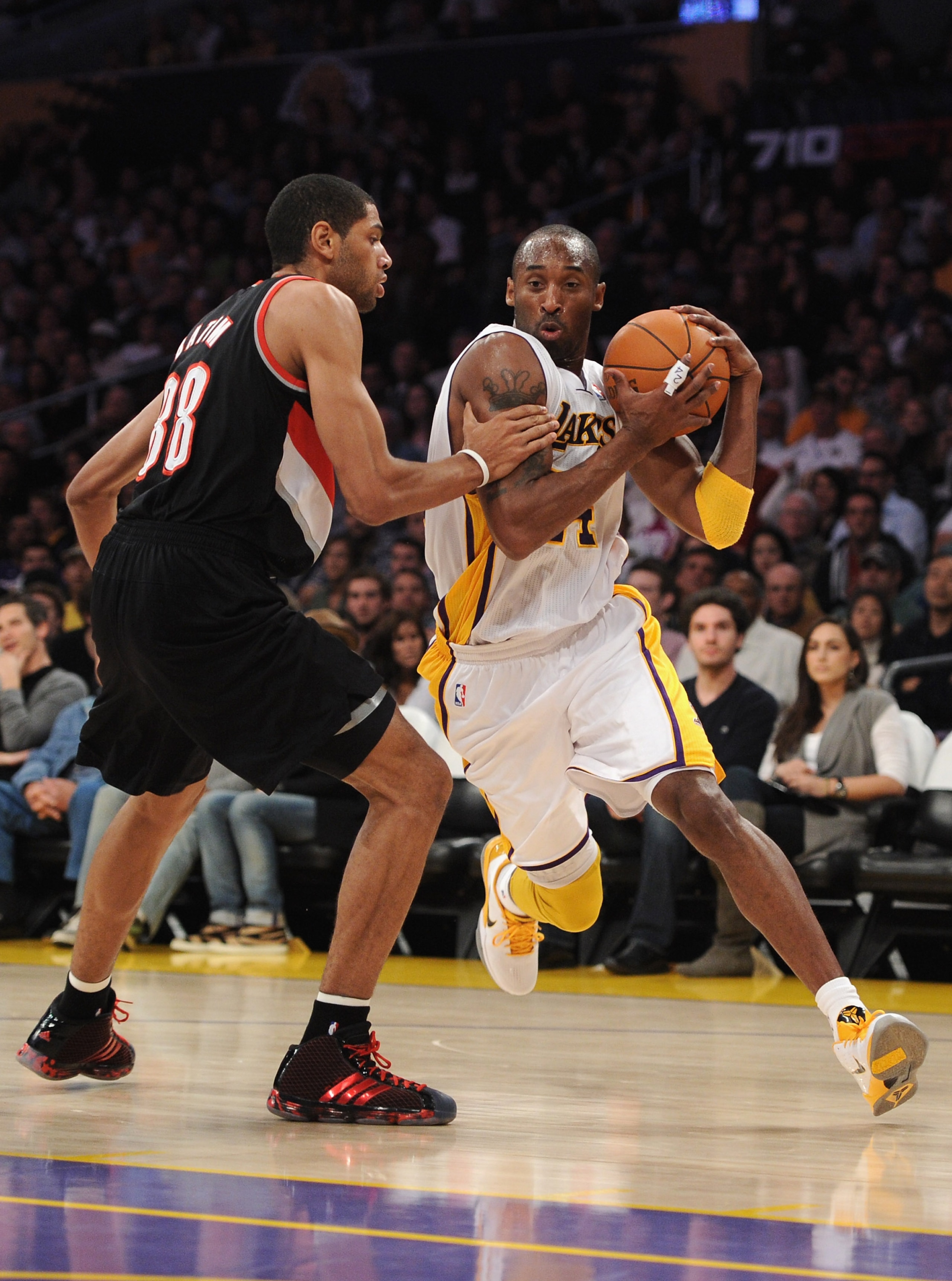 LOS ANGELES, CA - NOVEMBER 07:  Kobe Bryant #24 of the Los Angeles Lakers dribbles around Nicolas Batum of the Portland Trail Blazers at the Staples Center on November 7, 2010 in Los Angeles, California.  NOTE TO USER: User expressly acknowledges and agre