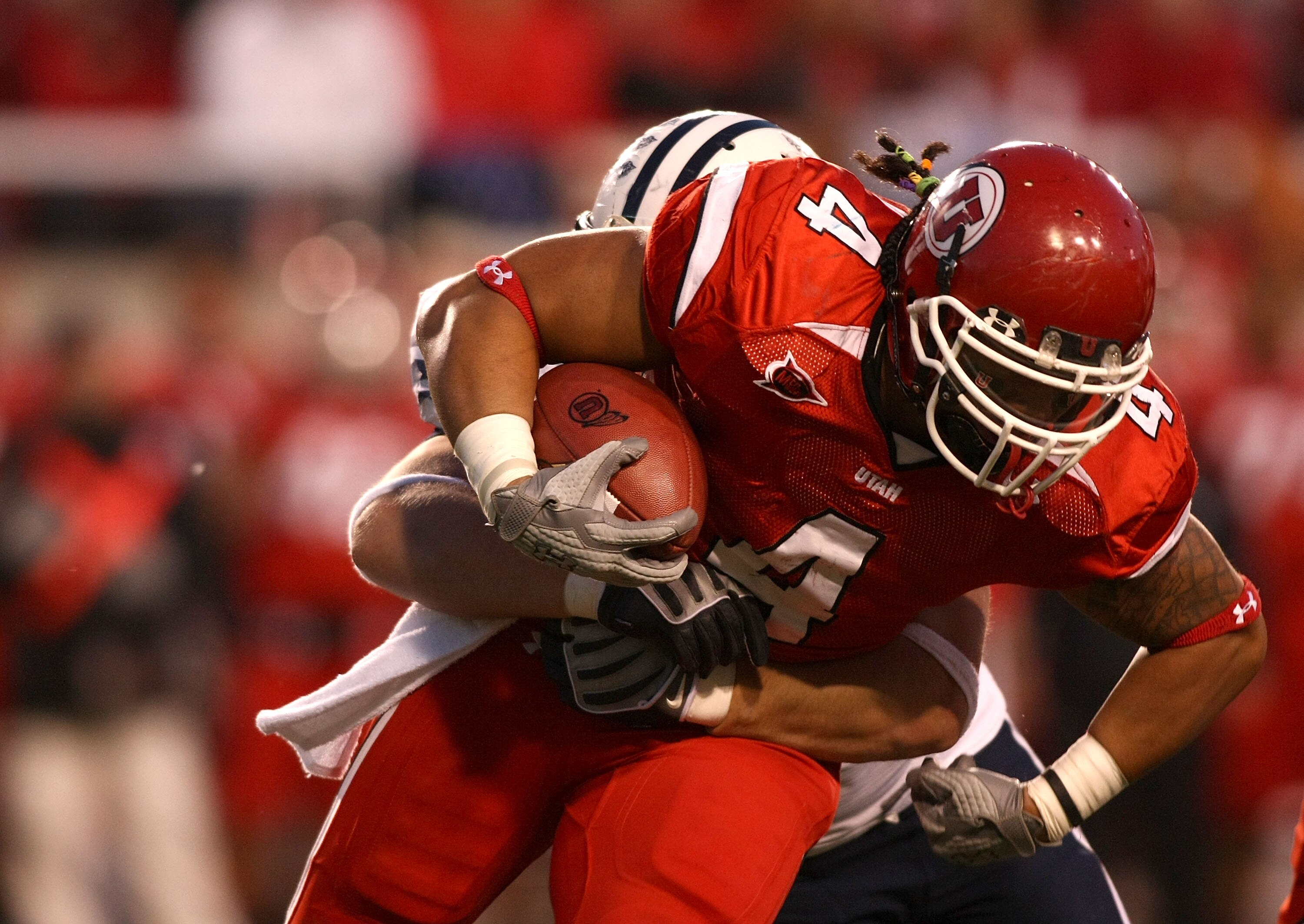SALT LAKE CITY - NOVEMBER 22:  Matt Asiata #4 of the Utah Utes runs with the ball against the BYU Cougars at Rice-Eccles Stadium on November 22, 2008 in Salt Lake City, Utah.  (Photo by Jonathan Ferrey/Getty Images)