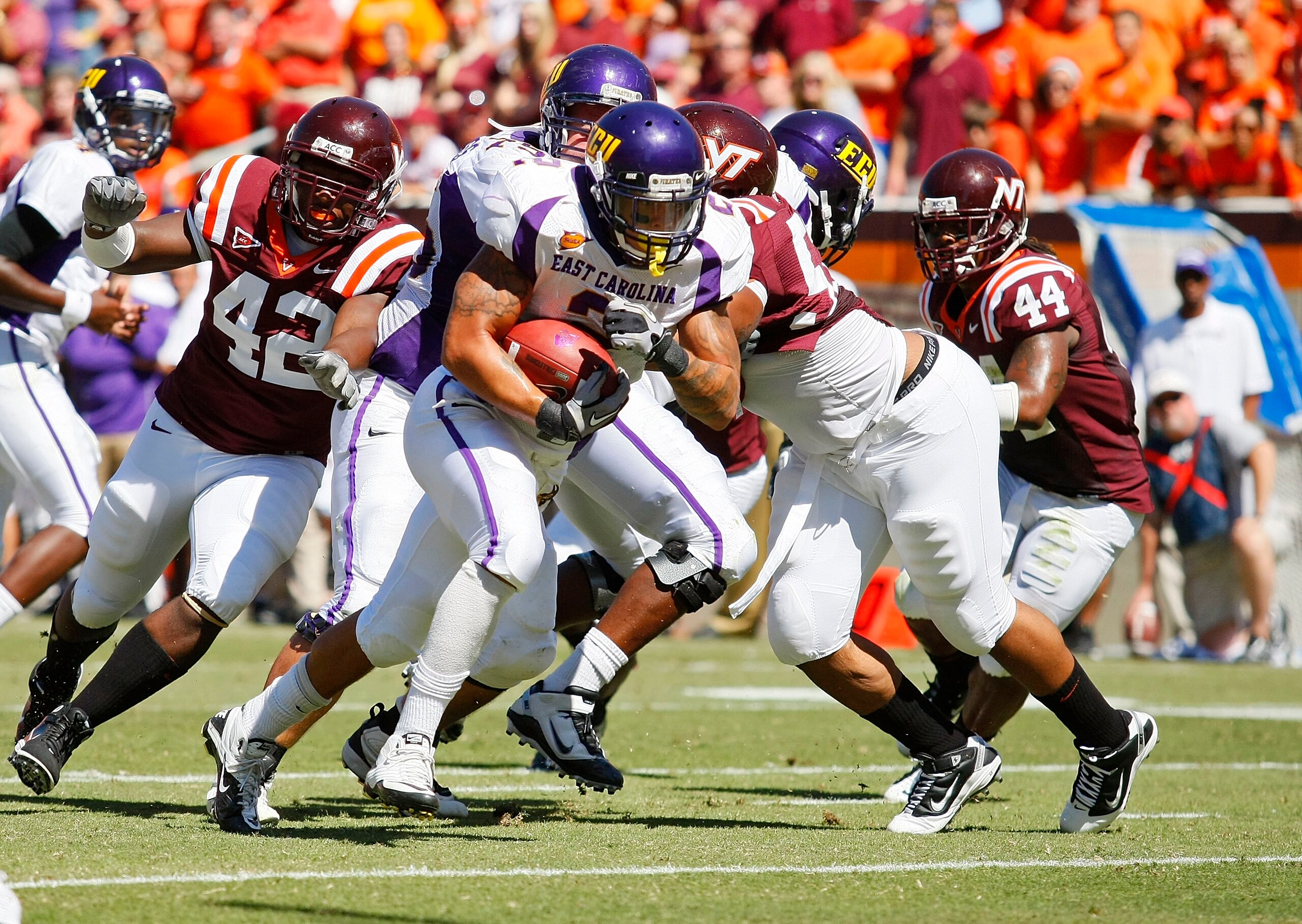 BLACKSBURG, VA - SEPTEMBER 18: Running back Jonathan Williams #2 of the East Carilona Pirates runs with the ball for a touchdown as defensive end J.R. Collins #42 of the Virginia Tech Hokies chases at Lane Stadium on September 18, 2010 in Blacksburg, Vir BLACKSBURG, VA - SEPTEMBER 18: Running back Jonathan Williams #2 of the East Carilona Pirates runs with the ball for a touchdown as defensive end J.R. Collins #42 of the Virginia Tech Hokies chases at Lane Stadium on September 18, 2010 in Blacksburg, Vir
