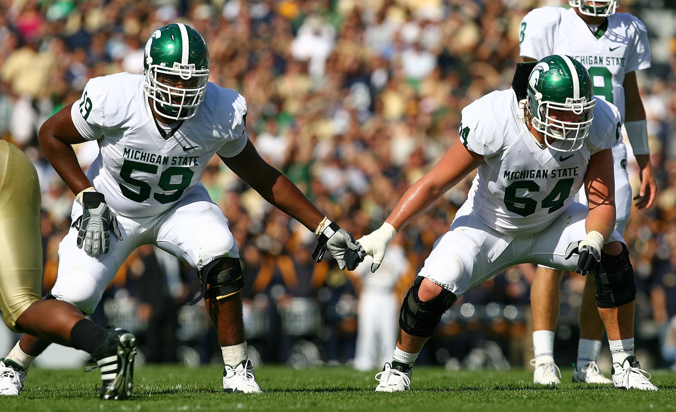 SOUTH BEND, IN - SEPTEMBER 19: D.J. Young #59 and Brendon Moss #64 of the Michigan State Spartans await the start of play against the Notre Dame Fighting Irish on September 19, 2009 at Notre Dame Stadium in South Bend, Indiana. Notre Dame defeated Michiga SOUTH BEND, IN - SEPTEMBER 19: D.J. Young #59 and Brendon Moss #64 of the Michigan State Spartans await the start of play against the Notre Dame Fighting Irish on September 19, 2009 at Notre Dame Stadium in South Bend, Indiana. Notre Dame defeated Michiga