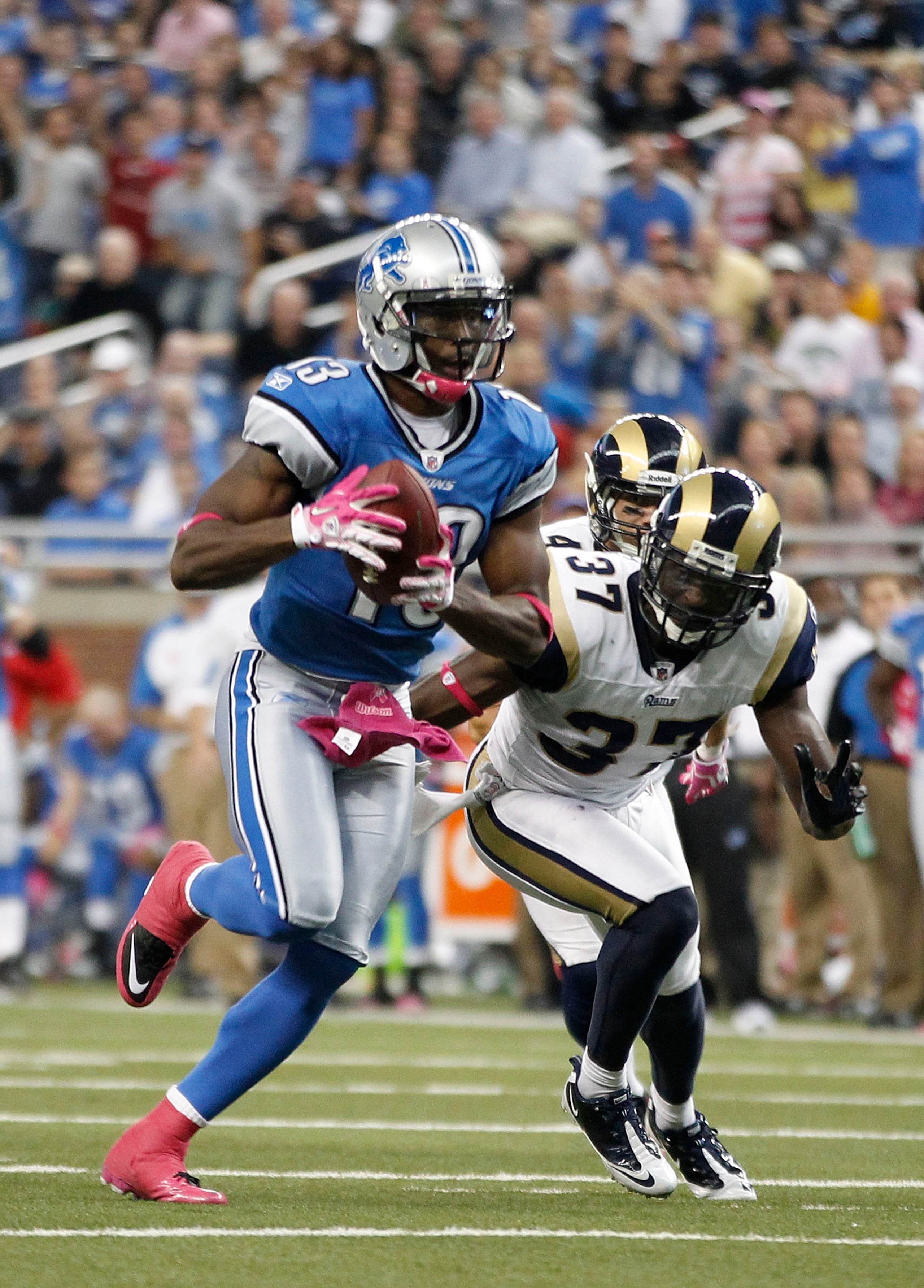 DETROIT - OCTOBER 10:  Nate Burleson #13 of the Detroit Lions scores a third quarter touchdown on a 21 yard pass from Shaun Hill #14 during the third quarter of the game against the St. Louis Rams during the second quarter of the game at Ford Field on Oct
