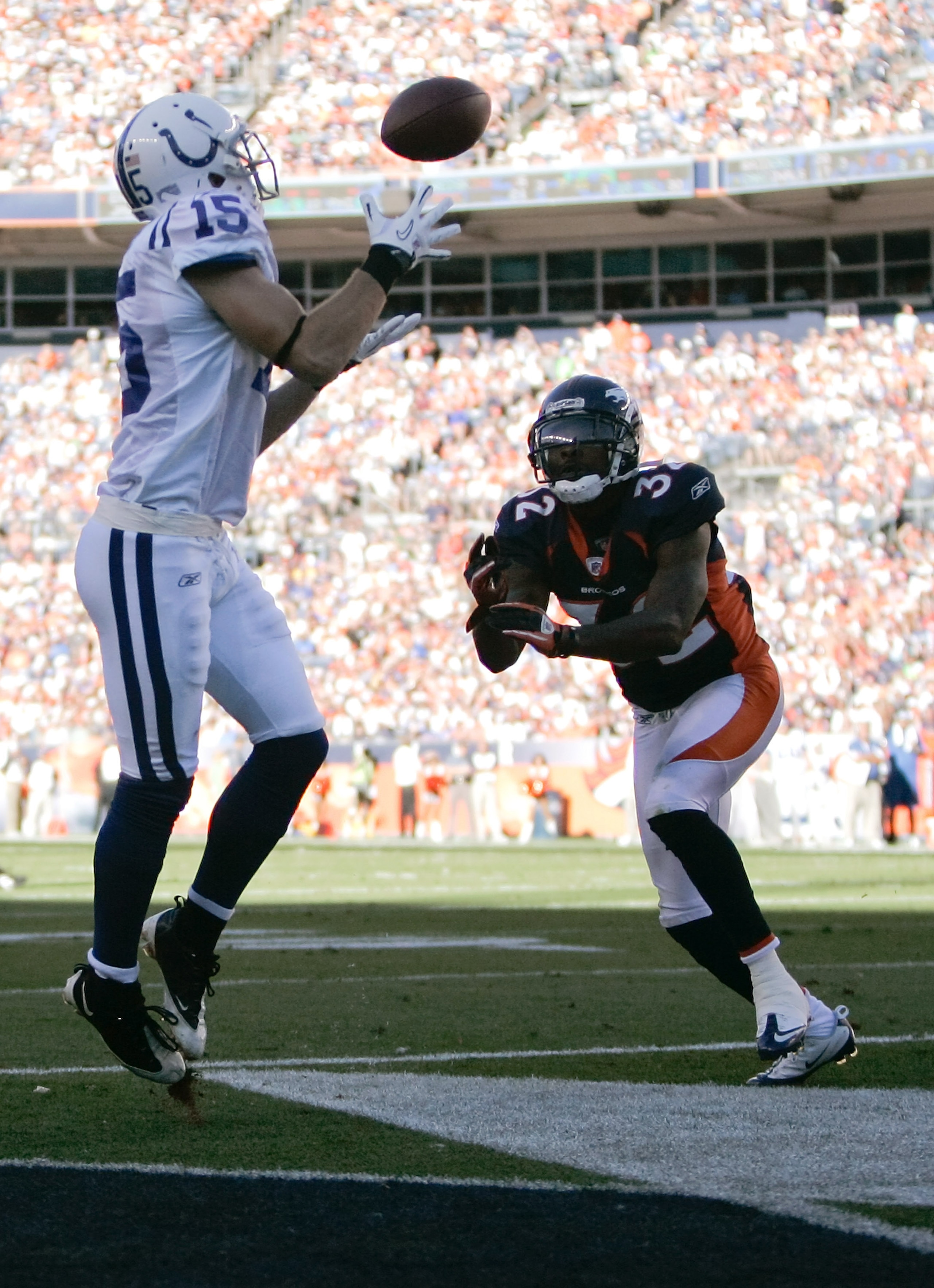 DENVER - SEPTEMBER 26:  Wide receiver Blair White #15 of the Indianapolis Colts makes a catch for a touchdown against cornerback Perrish Cox #32 of the Denver Broncos during NFL action at INVESCO Field at Mile High on September 26, 2010 in Denver, Colorad