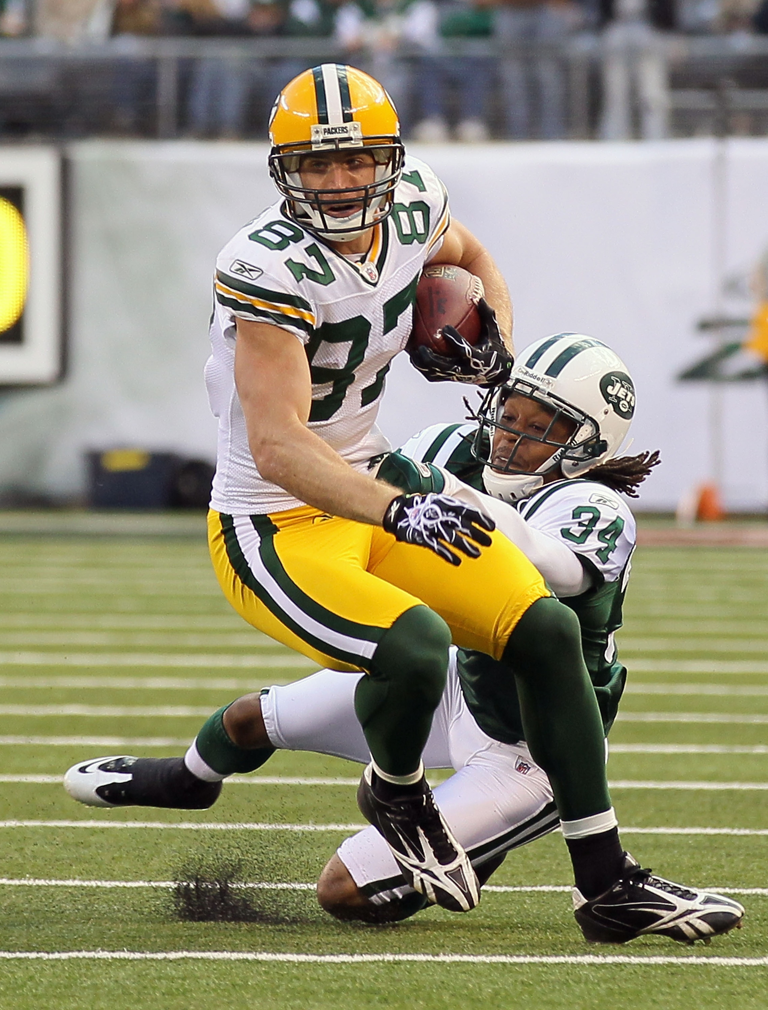 EAST RUTHERFORD, NJ - OCTOBER 31:  Jordy Nelson #87 of the Green Bay Packers runs the ball against Marquice Cole #34 of the New York Jets on October 31, 2010 at the New Meadowlands Stadium in East Rutherford, New Jersey. The Packers defeated the Jets 9-0.