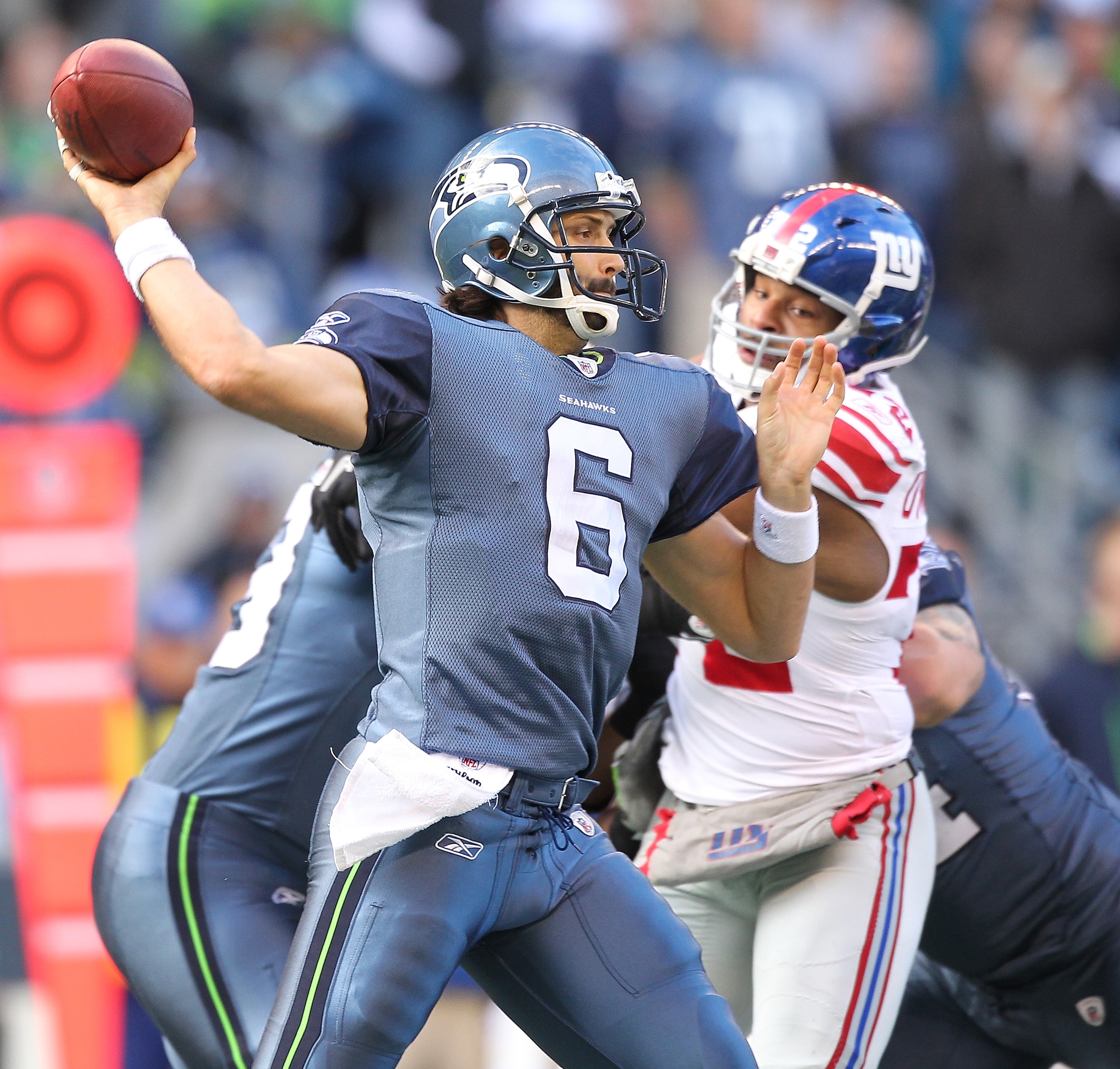 SEATTLE - NOVEMBER 07:  Quarterback Charlie Whitehurst #6 of the Seattle Seahawks passes against  Osi Umenyiora #72 of the New York Giants at Qwest Field on November 7, 2010 in Seattle, Washington. (Photo by Otto Greule Jr/Getty Images)