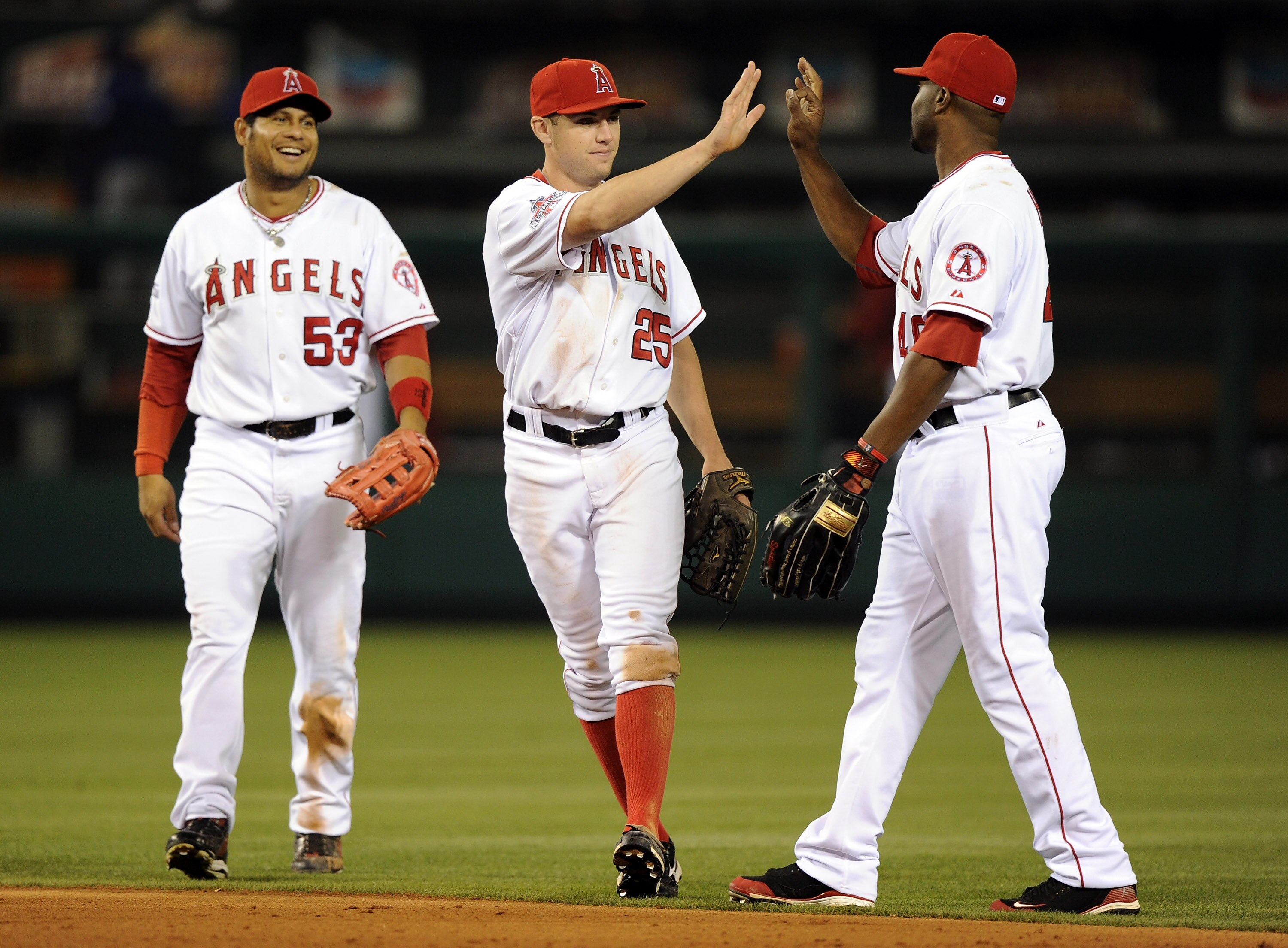 ANAHEIM, CA - SEPTEMBER 20:  Peter Bourjos #25, Bobby Abreu #53 and Torii Hunter #48 of the Los Angeles Angels of Anaheim celebrate a 7-4 win over the Texas Rangers during the ninth inning at Angel Stadium on September 20, 2010 in Anaheim, California.  (P