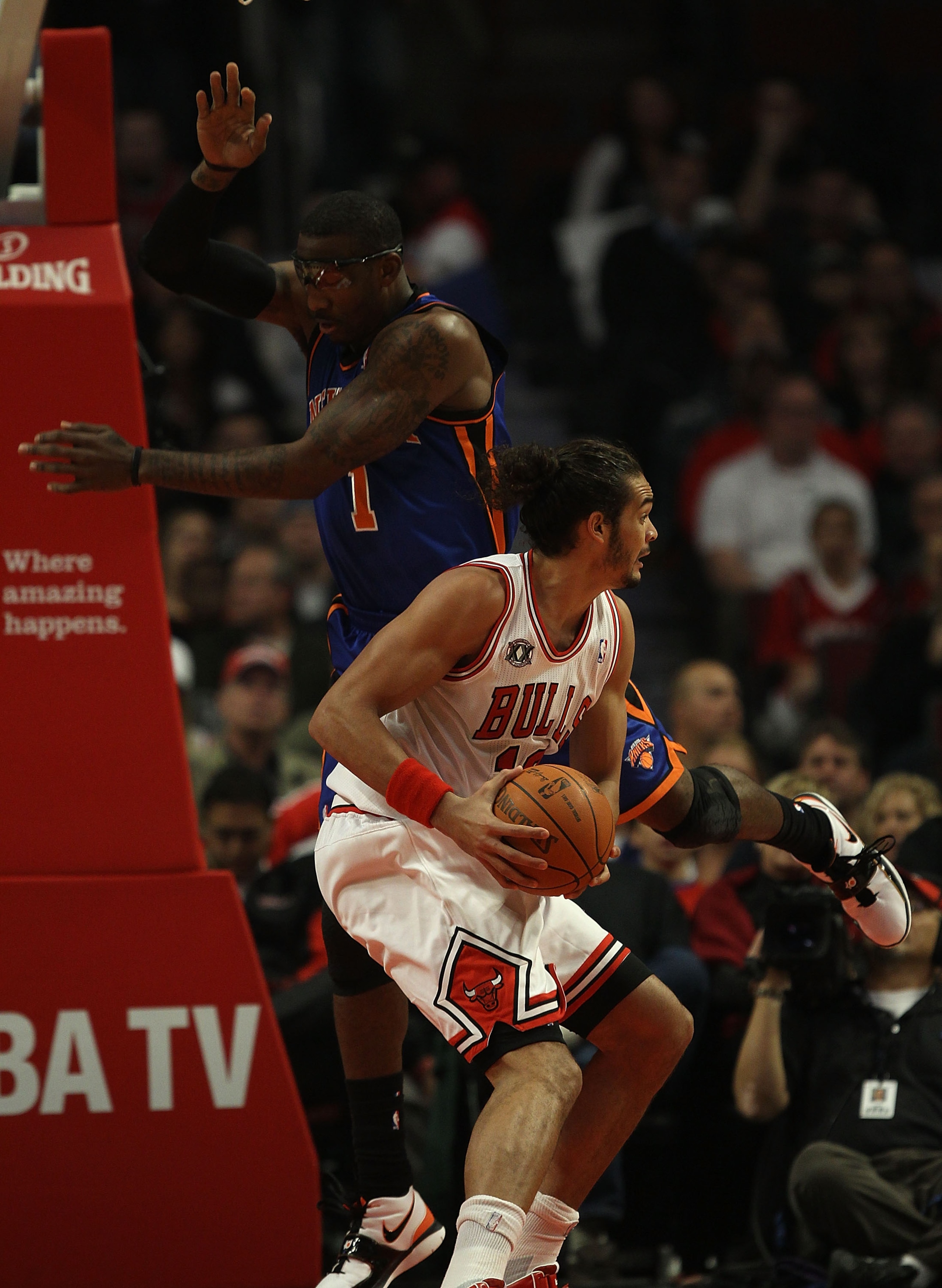 CHICAGO - NOVEMBER 04: Amar'e Stoudemire #1 of the New York Knicks tries to avoid fouling Joakim Noah #13 of the Chicago Bulls at the United Center on November 4, 2010 in Chicago, Illinois. NOTE TO USER: User expressly acknowledges and agrees that, by dow