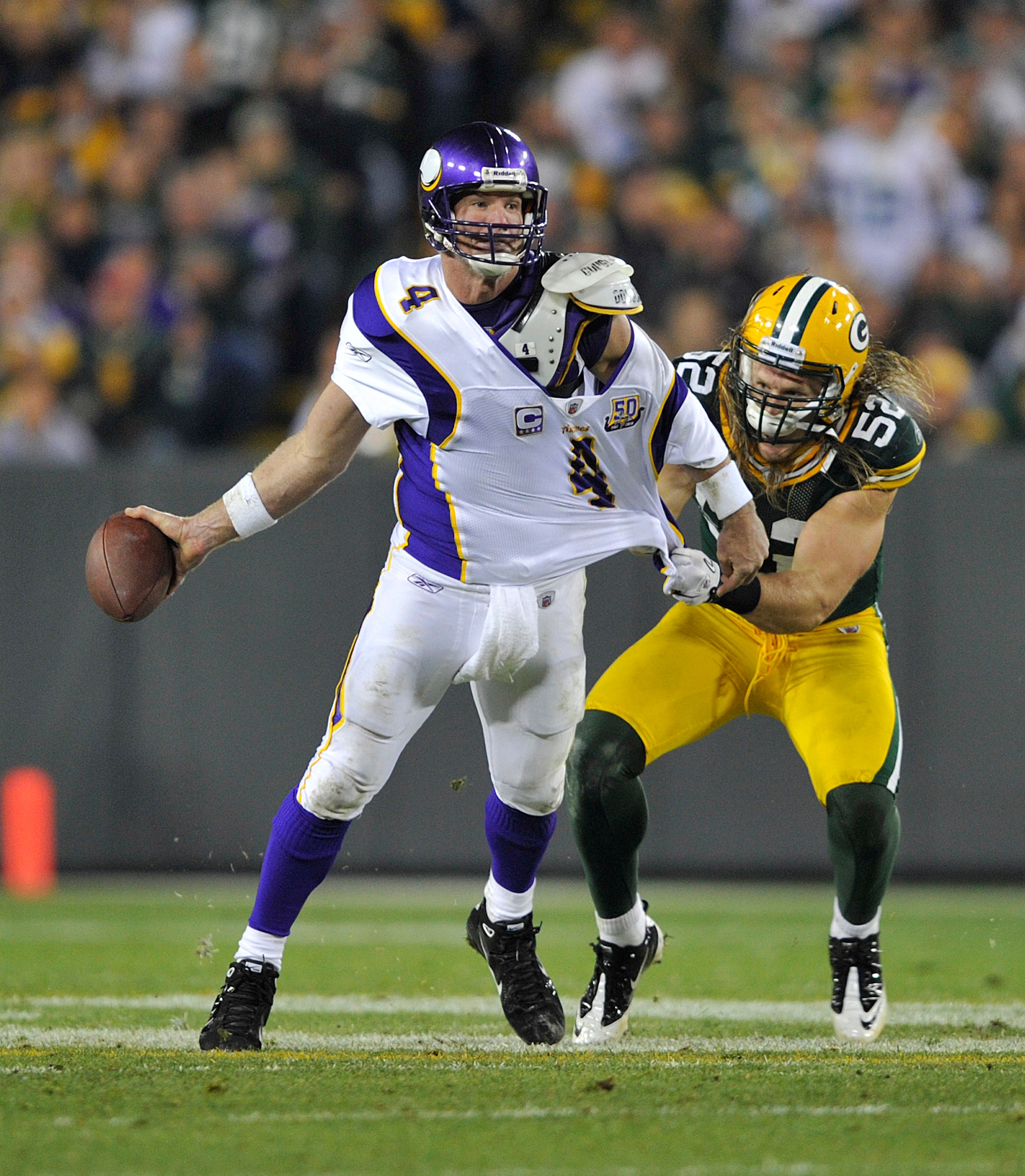 GREEN BAY, WI - OCTOBER 24:  Brett Favre #4 of the Minnesota Vikings has his jersey grabbed by Clay Matthews #52 of the Green Bay Packers at Lambeau Field on October 24, 2010 in Green Bay, Wisconsin. (Photo by Jim Prisching/Getty Images)