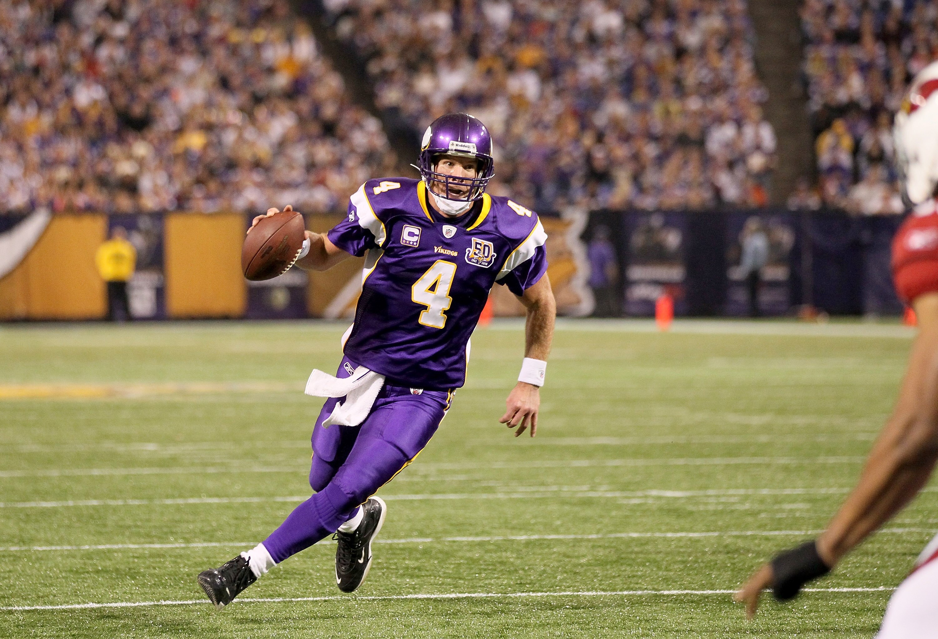MINNEAPOLIS - NOVEMBER 07:  Quarterback Brett Favre #4 of the Minnesota Vikings runs with the ball against the Arizona Cardinals at Hubert H. Humphrey Metrodome on November 7, 2010 in Minneapolis, Minnesota.  The Vikings won 27-24 in overtime.  (Photo by 