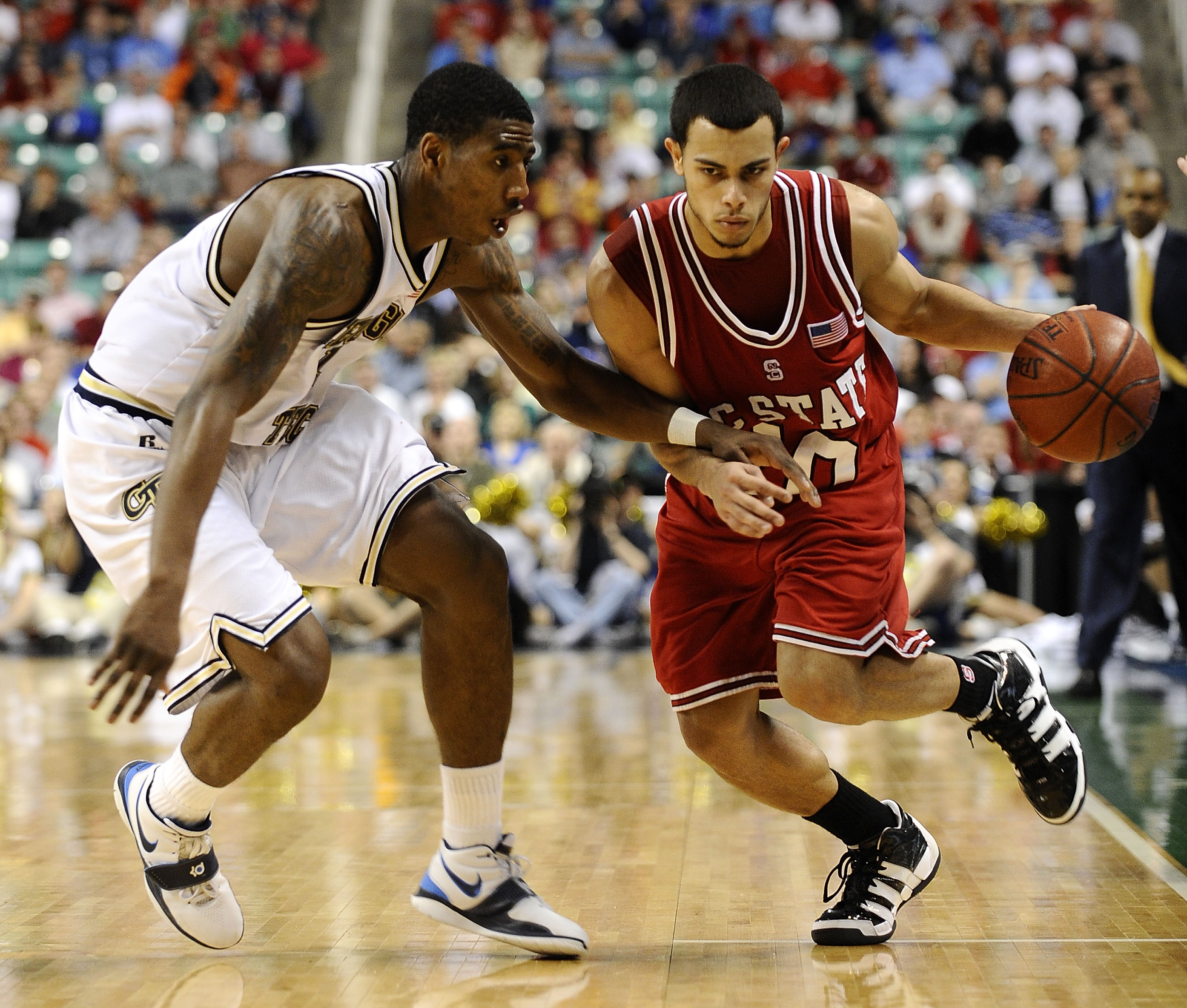 GREENSBORO, NC - MARCH 13:  Iman Shumpert #1 of the Georgia Tech Yellow Jackets guards Javier Gonzalez #10 of the North Carolina State Wolfpack in their semifinal game in the 2010 ACC Men's Basketball Tournament at the Greensboro Coliseum on on March 13,