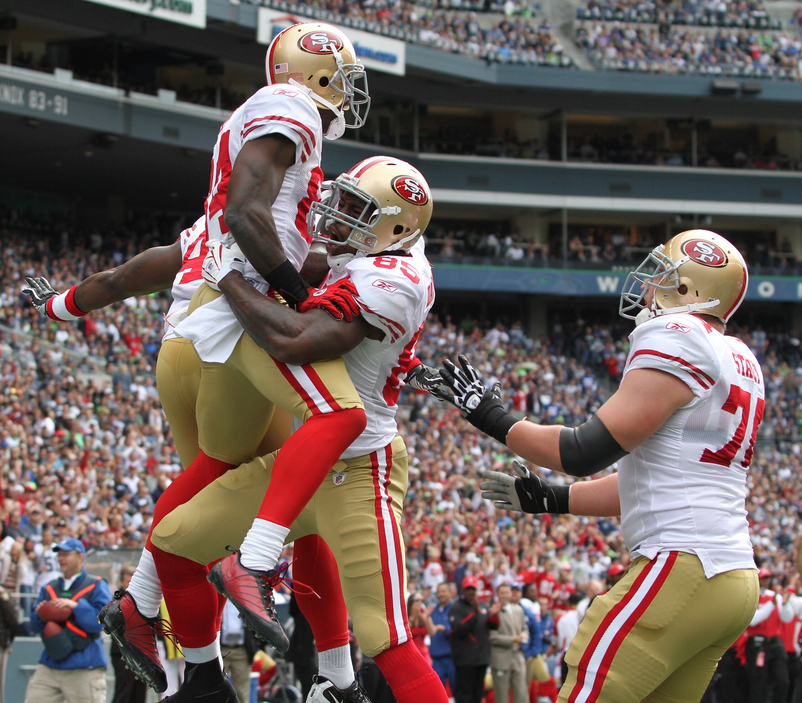 SEATTLE - SEPTEMBER 12:  Wide receiver Josh Morgan #84 of the San Francisco 49ers celebrates with Vernon Davis #85 and Joe Staley #74 after scoring an apparent touchdown during the NFL season opener against the Seattle Seahawks at Qwest Field on September