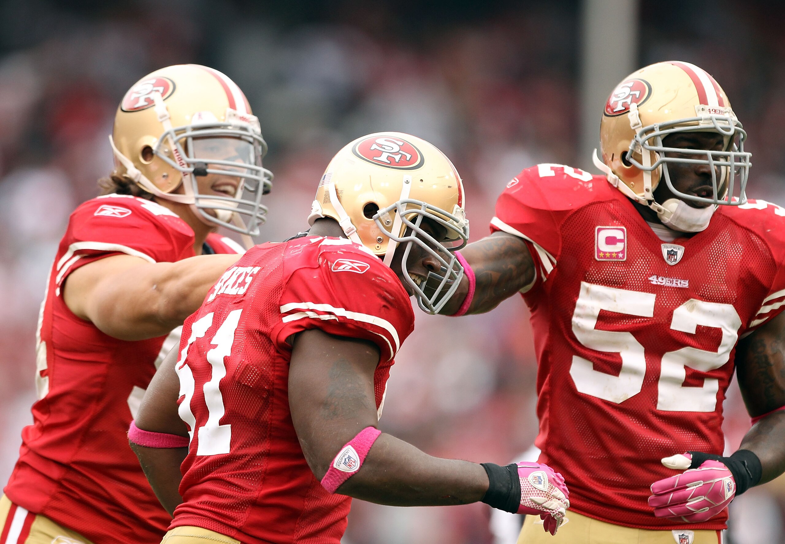 SAN FRANCISCO - OCTOBER 17:  Takeo Spikes #51 of the San Francisco 49ers is congratulated by teammates after he made an interception during their game against the Oakland Raiders at Candlestick Park on October 17, 2010 in San Francisco, California.  (Phot
