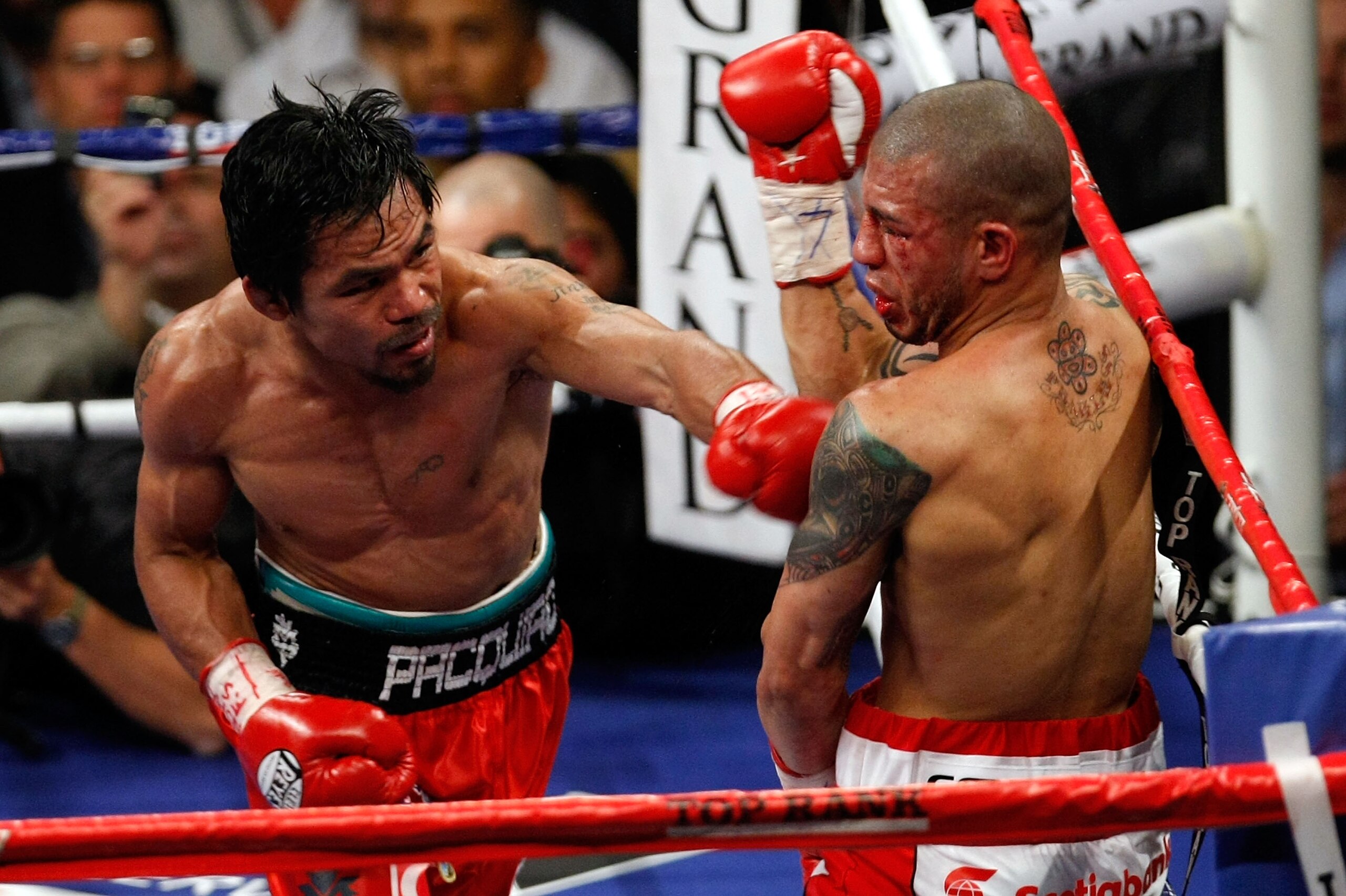 LAS VEGAS - NOVEMBER 14:  (L-R) Manny Pacquiao throws a left to the body of Miguel Cotto during their WBO welterweight title fight at the MGM Grand Garden Arena on November 14, 2009 in Las Vegas, Nevada. Pacquiao defeated Cotto by 12th round TKO.  (Photo