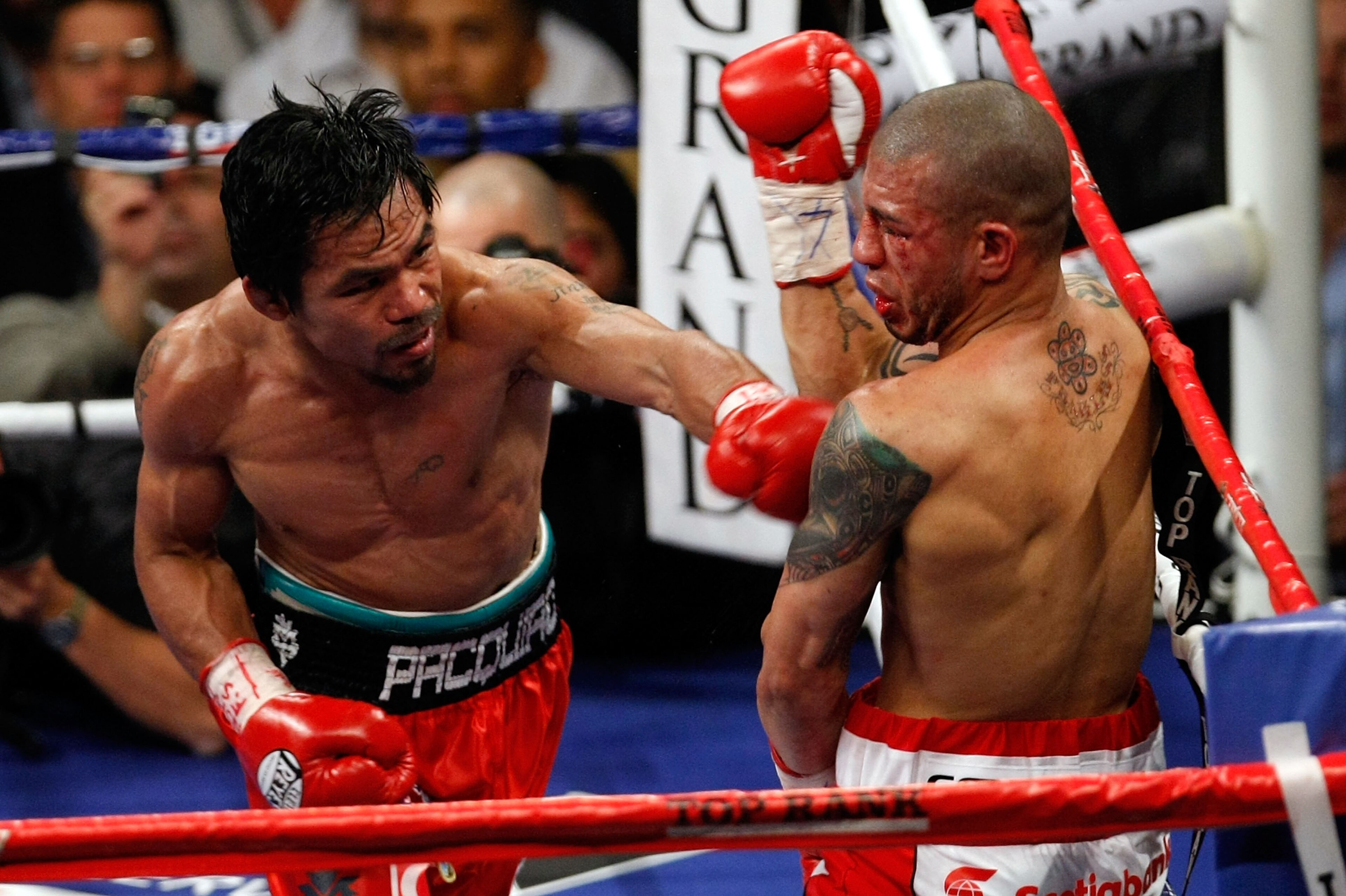 LAS VEGAS - NOVEMBER 14:  (L-R) Manny Pacquiao throws a left to the body of Miguel Cotto during their WBO welterweight title fight at the MGM Grand Garden Arena on November 14, 2009 in Las Vegas, Nevada. Pacquiao defeated Cotto by 12th round TKO.  (Photo