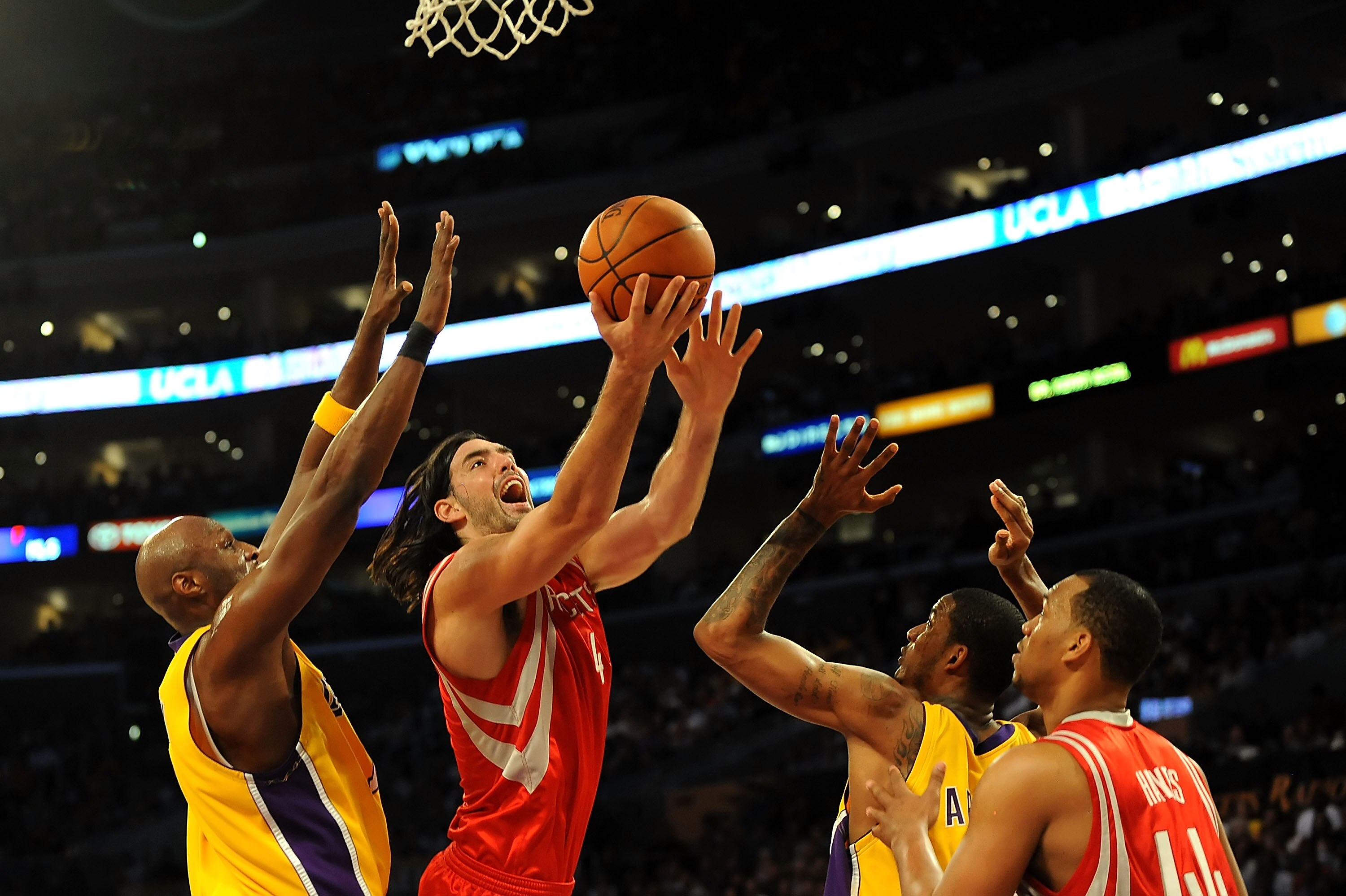 LOS ANGELES, CA - MAY 06:  Luis Scola #4 of the Houston Rockets goes up for a shot between Lamar Odom #7 and Trevor Ariza #3 of the Los Angeles Lakers in Game Two of the Western Conference Semifinals during the 2009 NBA Playoffs at Staples Center on May 6