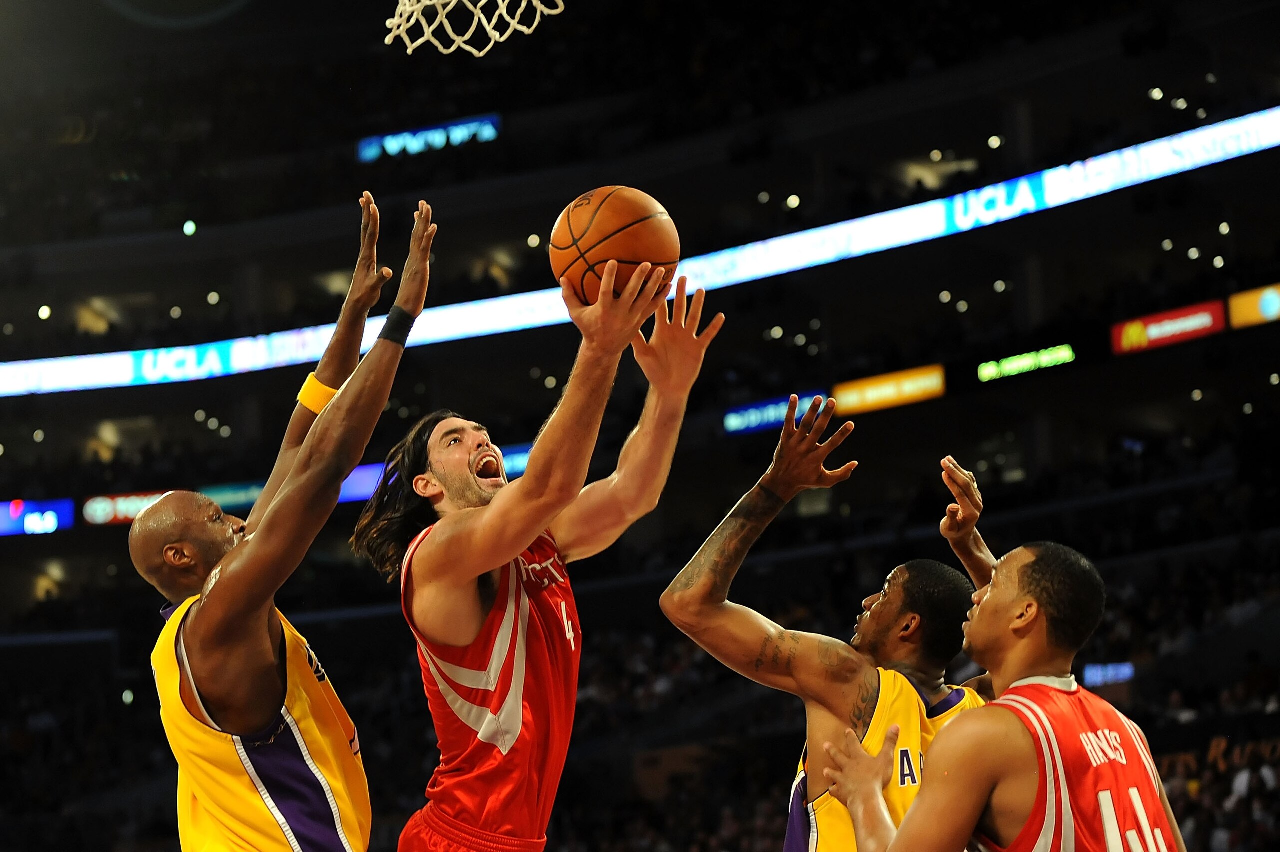 LOS ANGELES, CA - MAY 06:  Luis Scola #4 of the Houston Rockets goes up for a shot between Lamar Odom #7 and Trevor Ariza #3 of the Los Angeles Lakers in Game Two of the Western Conference Semifinals during the 2009 NBA Playoffs at Staples Center on May 6