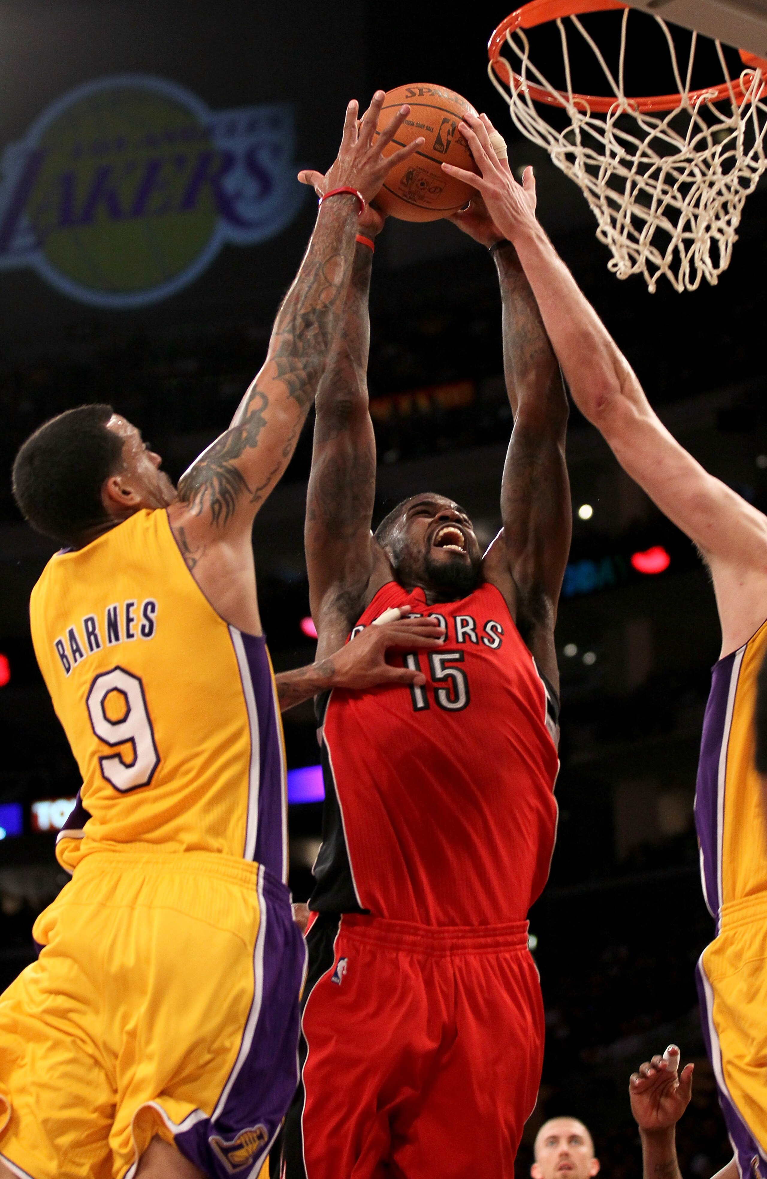 LOS ANGELES - NOVEMBER 5:  Amir Johnson #15 of  the Toronto Raptors goes in for a dunk agqainst Matt Barnes #9 of the Los Angeles Lakers at Staples Center on November 5, 2010 in Los Angeles, California.  The Lakers won 108-102.   NOTE TO USER: User expres