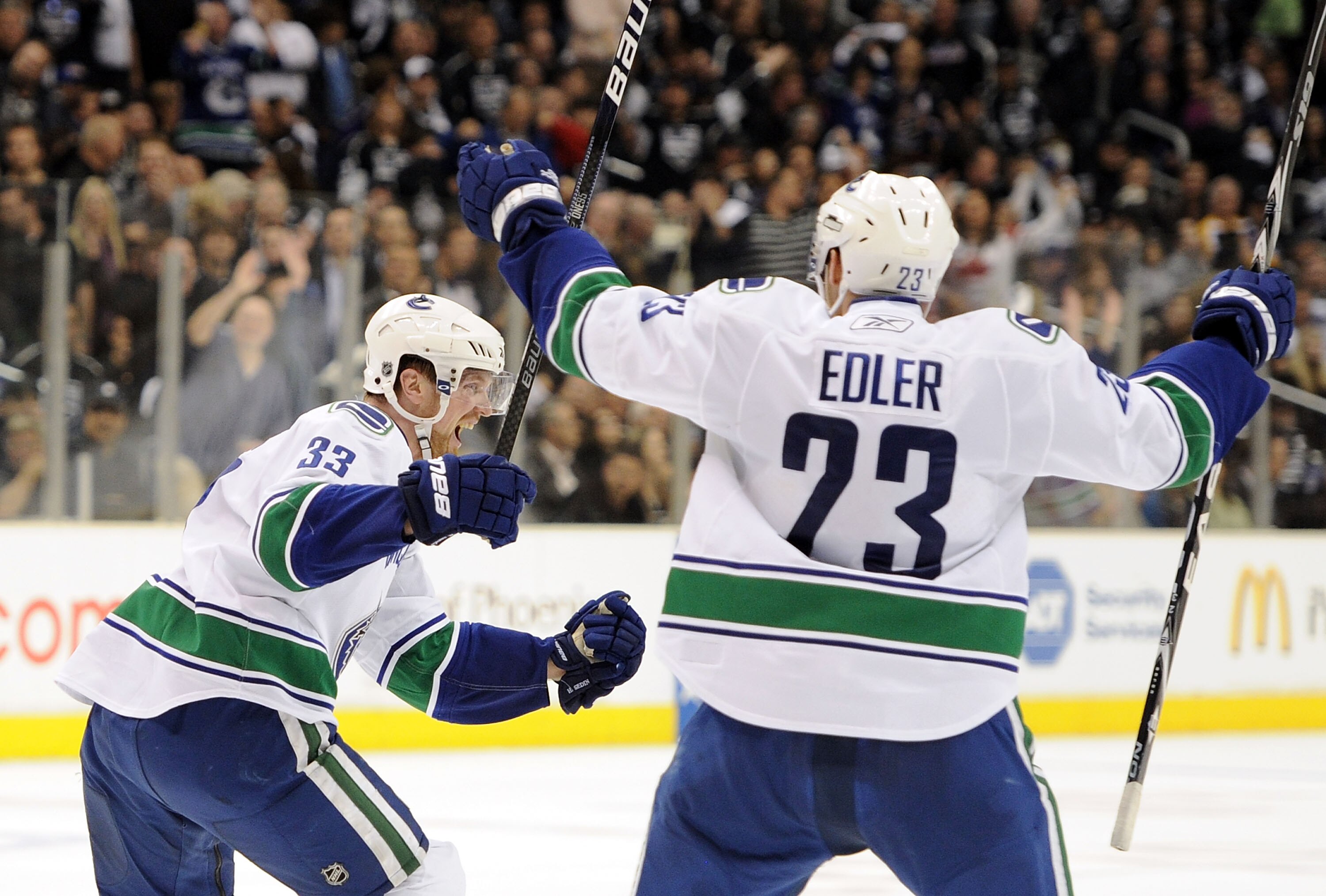 LOS ANGELES, CA - APRIL 21:  Henrik Sedin #33 of the Vancouver Canucks celebrates his go ahead goal with Alexander Edler #23 for a 5-4 lead over the Los Angeles Kings during the third period in game four of the Western Conference Quarter-final at Staples