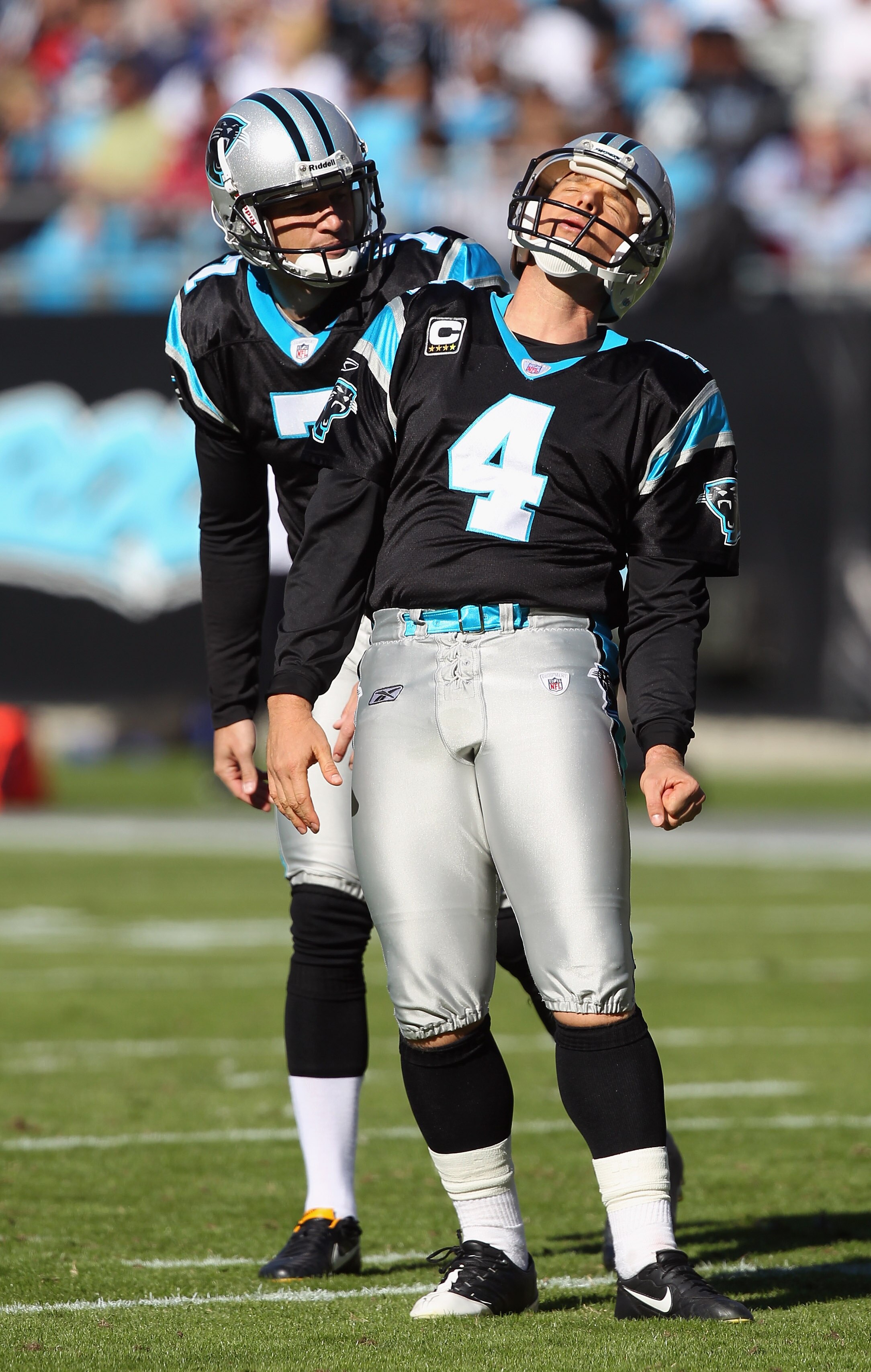 CHARLOTTE, NC - NOVEMBER 07:  Teammates Jason Baker #7 and John Kasay #4 of the Carolina Panthers react to a missed field goal against the New Orleans Saints during their game at Bank of America Stadium on November 7, 2010 in Charlotte, North Carolina.  (