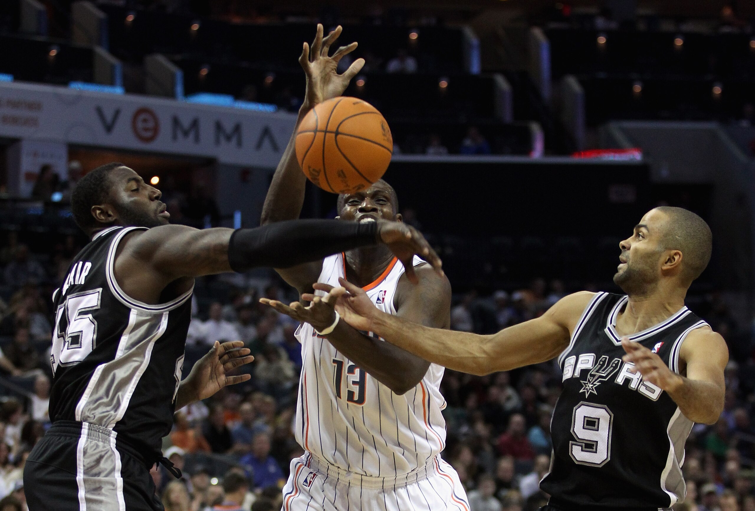 CHARLOTTE, NC - NOVEMBER 08:  Teammates Tony Parker #9 and DeJuan Blair #45 of the San Antonio Spurs battle for a loose ball with Nazr Mohammed #13 of the Charlotte Bobcats during their game at Time Warner Cable Arena on November 8, 2010 in Charlotte, Nor