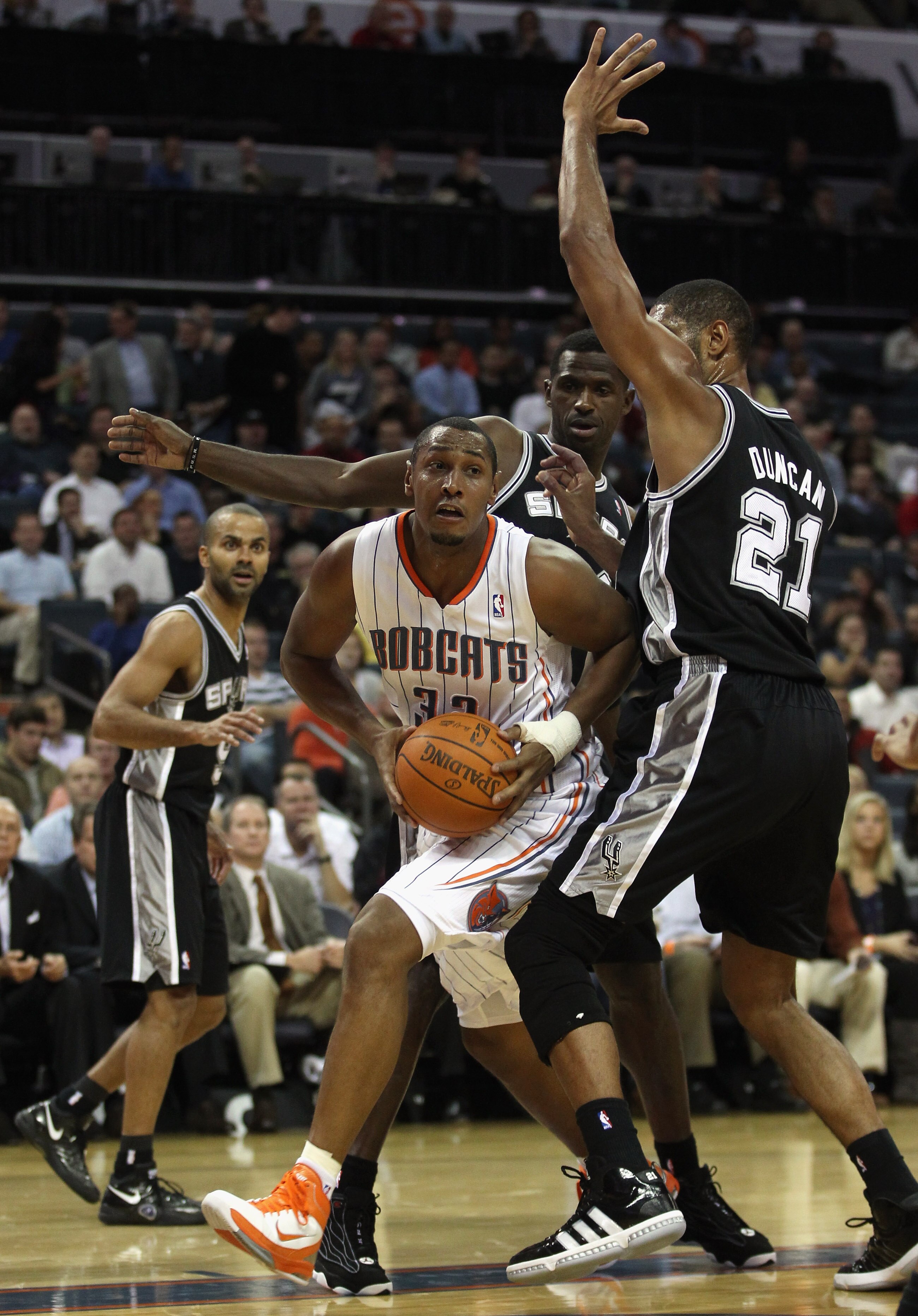 CHARLOTTE, NC - NOVEMBER 08:  Teammates Antonio McDyess #34 and Tim Duncan #21 of the San Antonio Spurs try to stop Boris Diaw #32 of the Charlotte Bobcats during their game at Time Warner Cable Arena on November 8, 2010 in Charlotte, North Carolina.  NOT