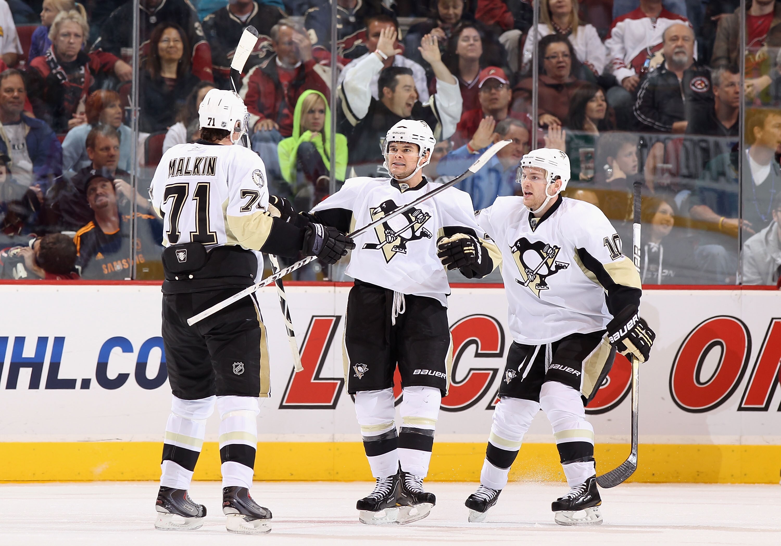 GLENDALE, AZ - NOVEMBER 06:  Chris Kunitz #14 of the Pittsburgh Penguins celebrates with teammates Evgeni Malkin #71 and Mark Letestu #10 after Kunitz scored a second period power play goal against the Phoenix Coyotes during the NHL game at Jobing.com Are