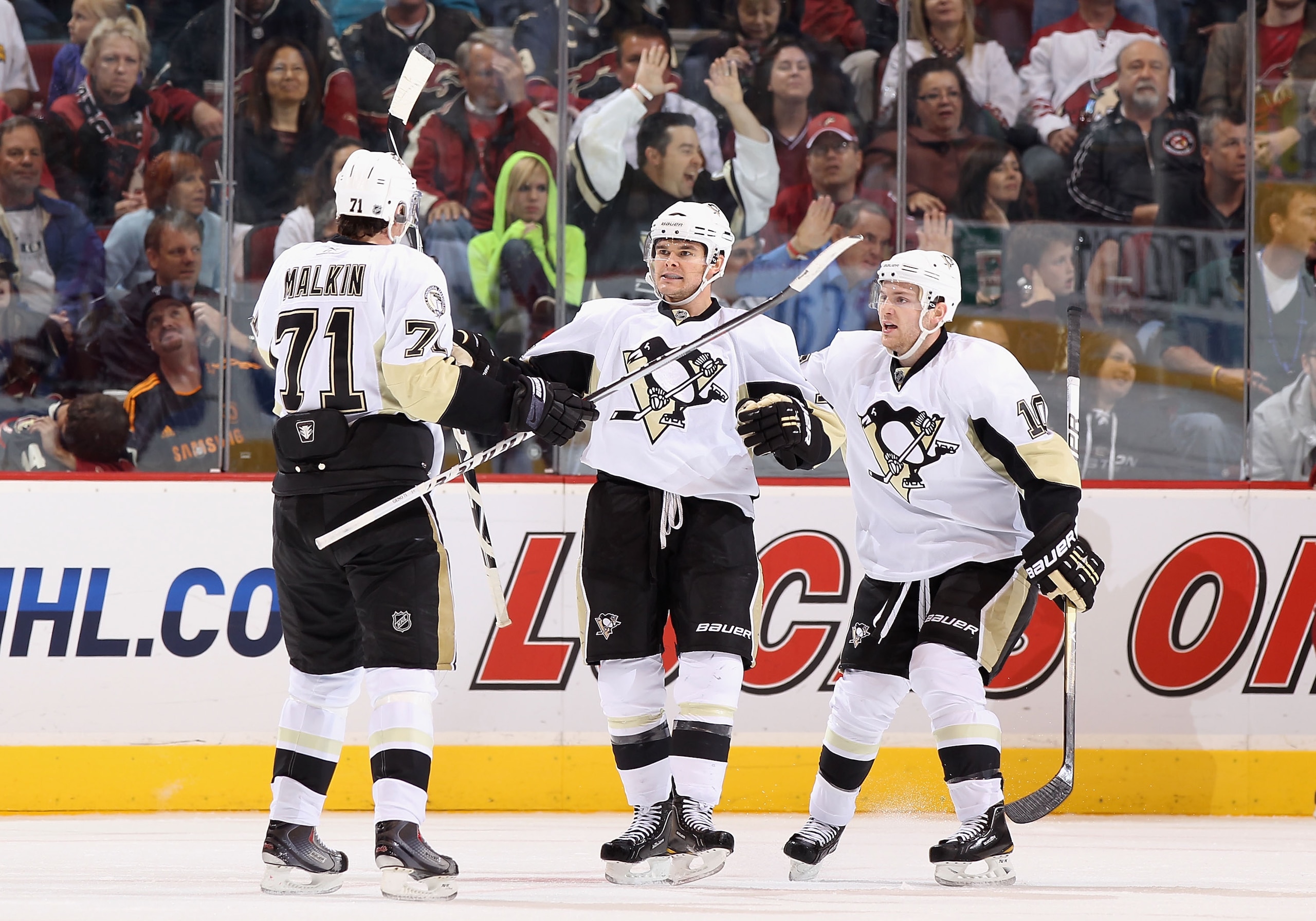 GLENDALE, AZ - NOVEMBER 06:  Chris Kunitz #14 of the Pittsburgh Penguins celebrates with teammates Evgeni Malkin #71 and Mark Letestu #10 after Kunitz scored a second period power play goal against the Phoenix Coyotes during the NHL game at Jobing.com Are
