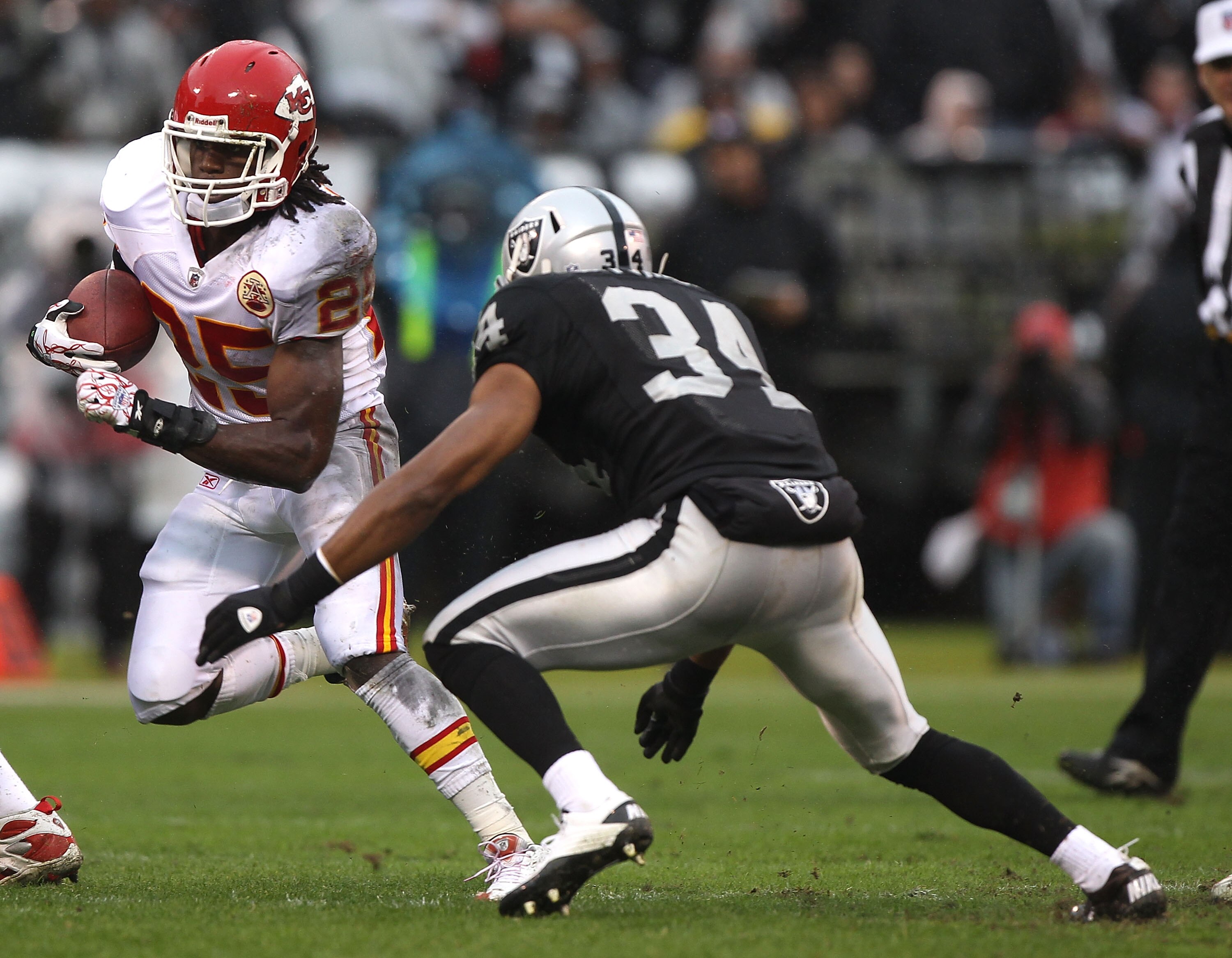 OAKLAND, CA - NOVEMBER 07:  Jamaal Charles #25 of the Kansas City Chiefs runs against Mike Mitchell #34 of the Oakland Raiders during an NFL game at Oakland-Alameda County Coliseum on November 7, 2010 in Oakland, California.  (Photo by Jed Jacobsohn/Getty