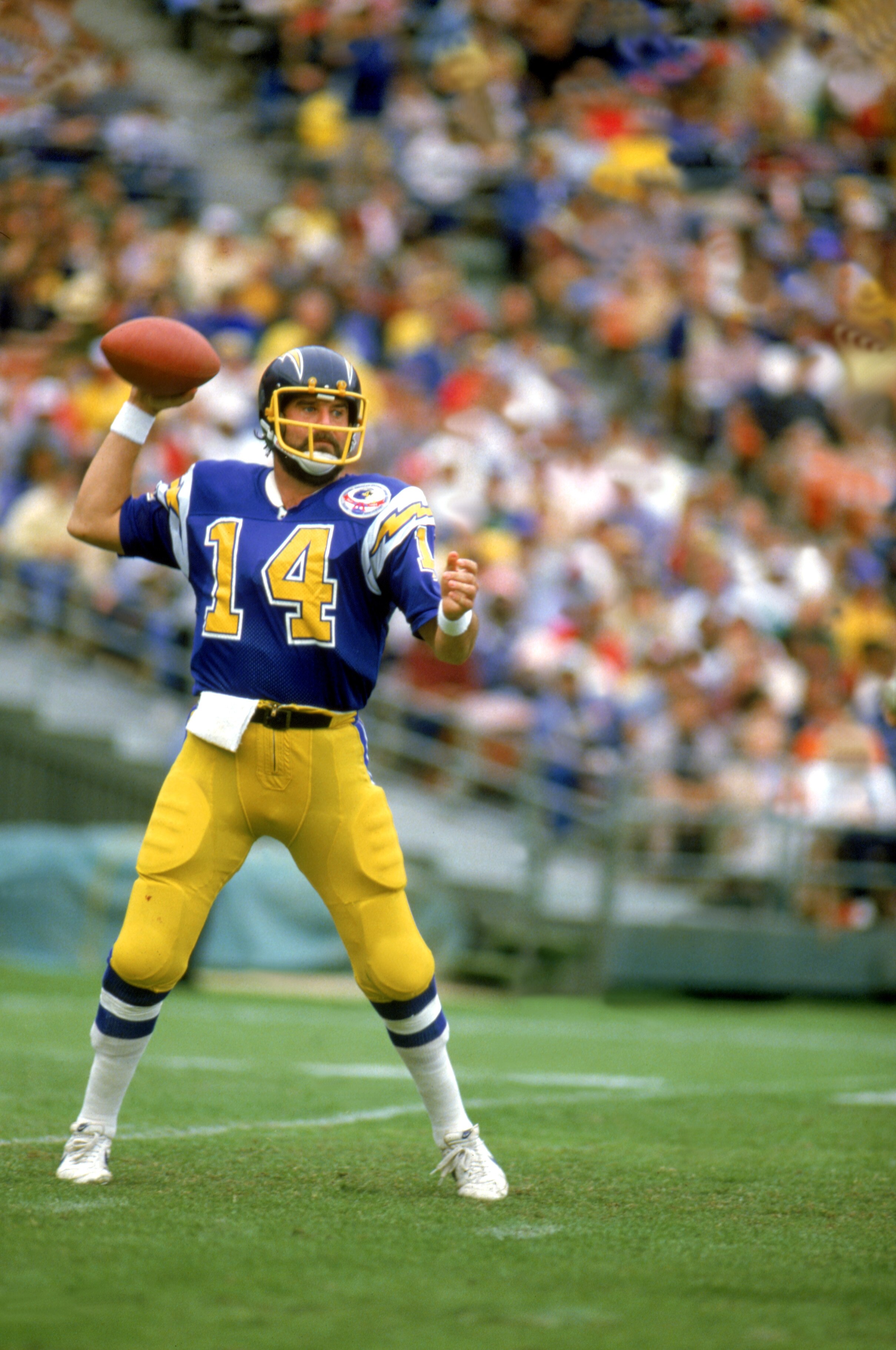 SAN DIEGO, CA - 1983:  Quarterback Dan Fouts #14 of the San Diego Chargers drops back to pass during a game at Jack Murphy Stadium during the 1983 NFL season in San Diego, California.  (Photo by Tony Duffy/Getty Images)