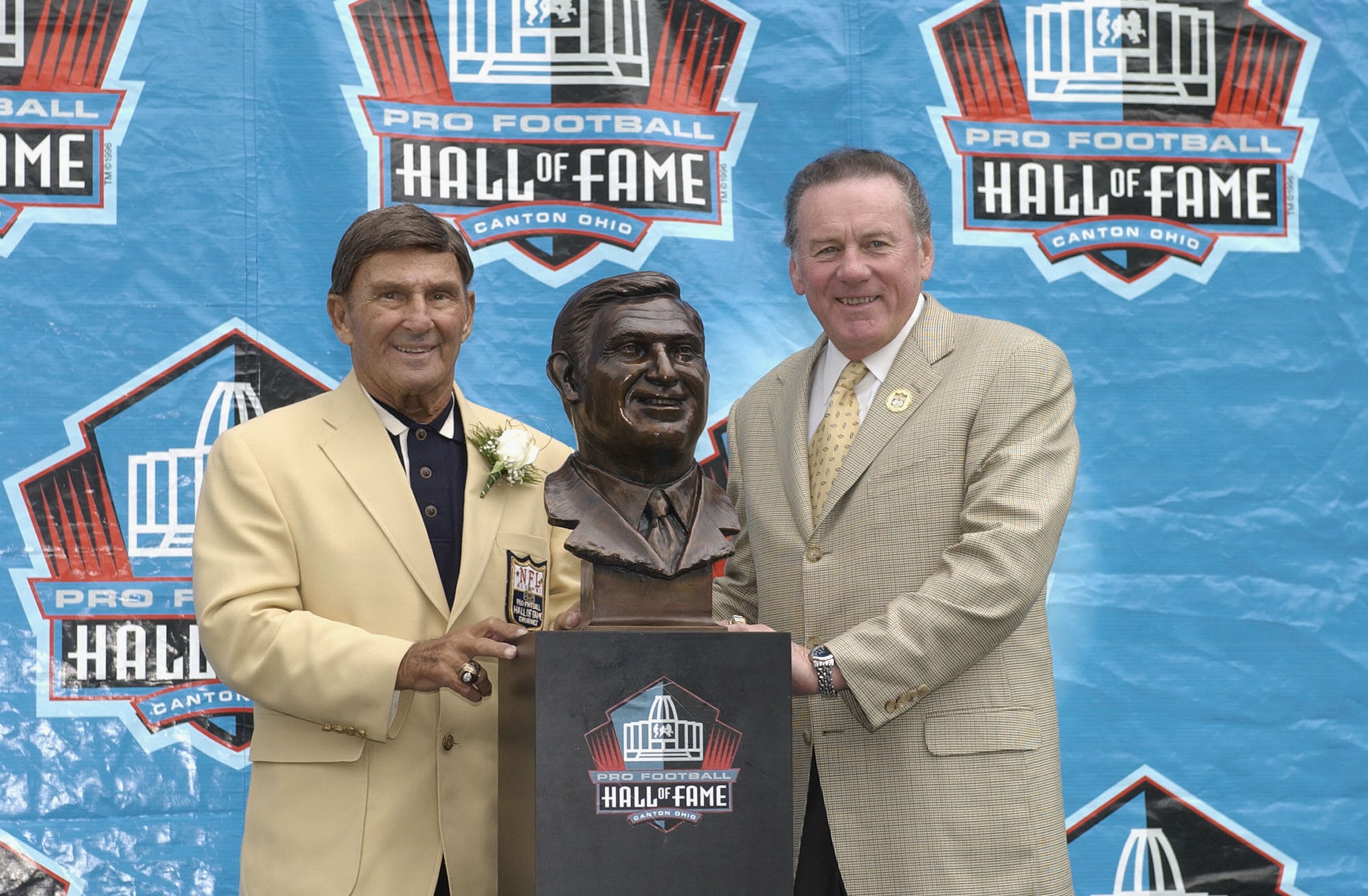 CANTON, OH - AUGUST 3:  Pro Football Hall of Fame inductee Hank Stram (L) poses with his bust and his presenter and fellow Hall of Famer Len Dawson during the 2003 NFL Hall of Fame Induction ceremony on August 3, 2003 in Canton, Ohio.  (Photo by David Max