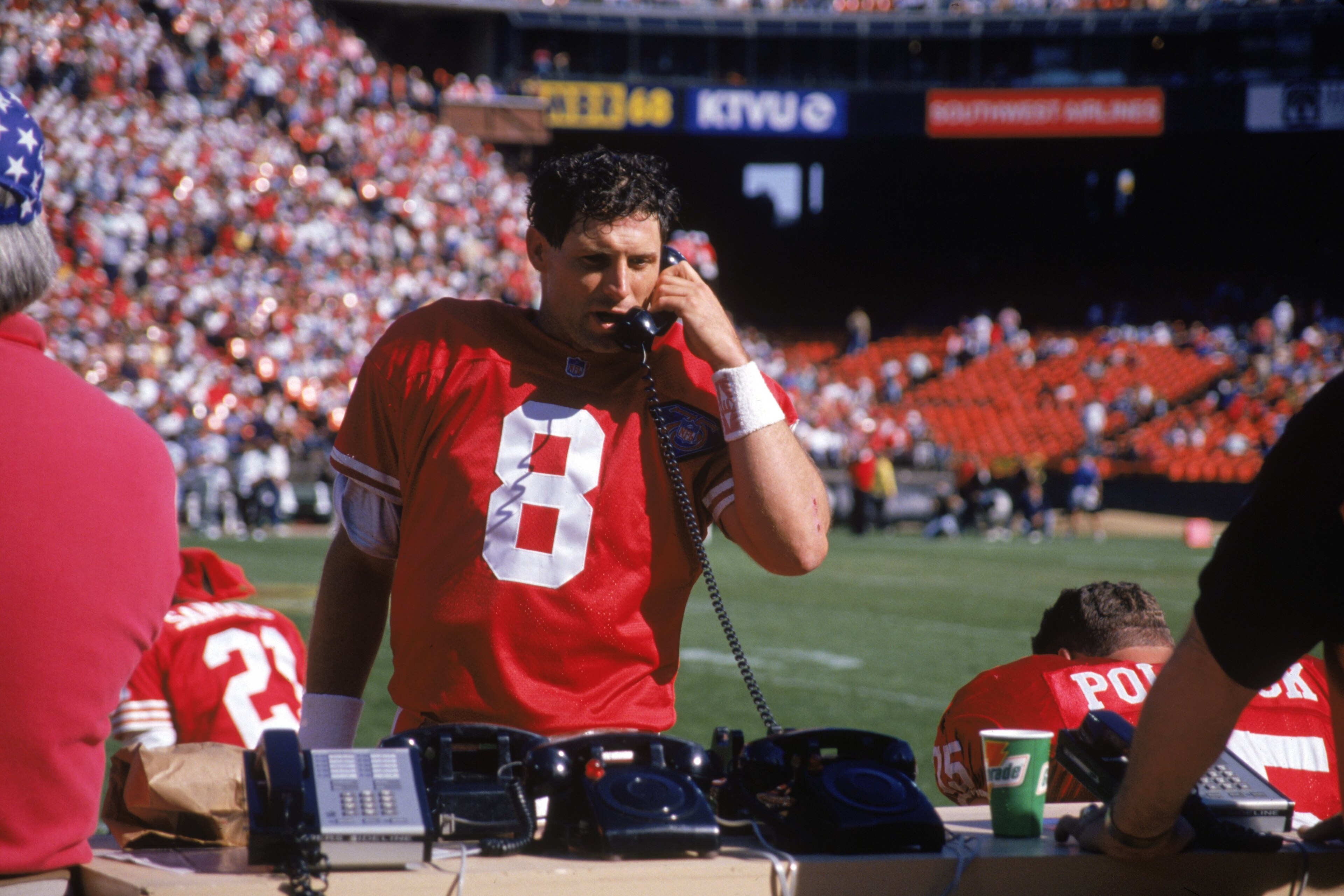 SAN FRANCISCO - OCTOBER 2:  Quarterback Steve Young #8 of the San Francisco 49ers uses the phone on the sideline during a game against the Philadelphia Eagles at Candlestick Park on October 2, 1994 in San Francisco, California.  The Eagles won 40-8.  (Pho