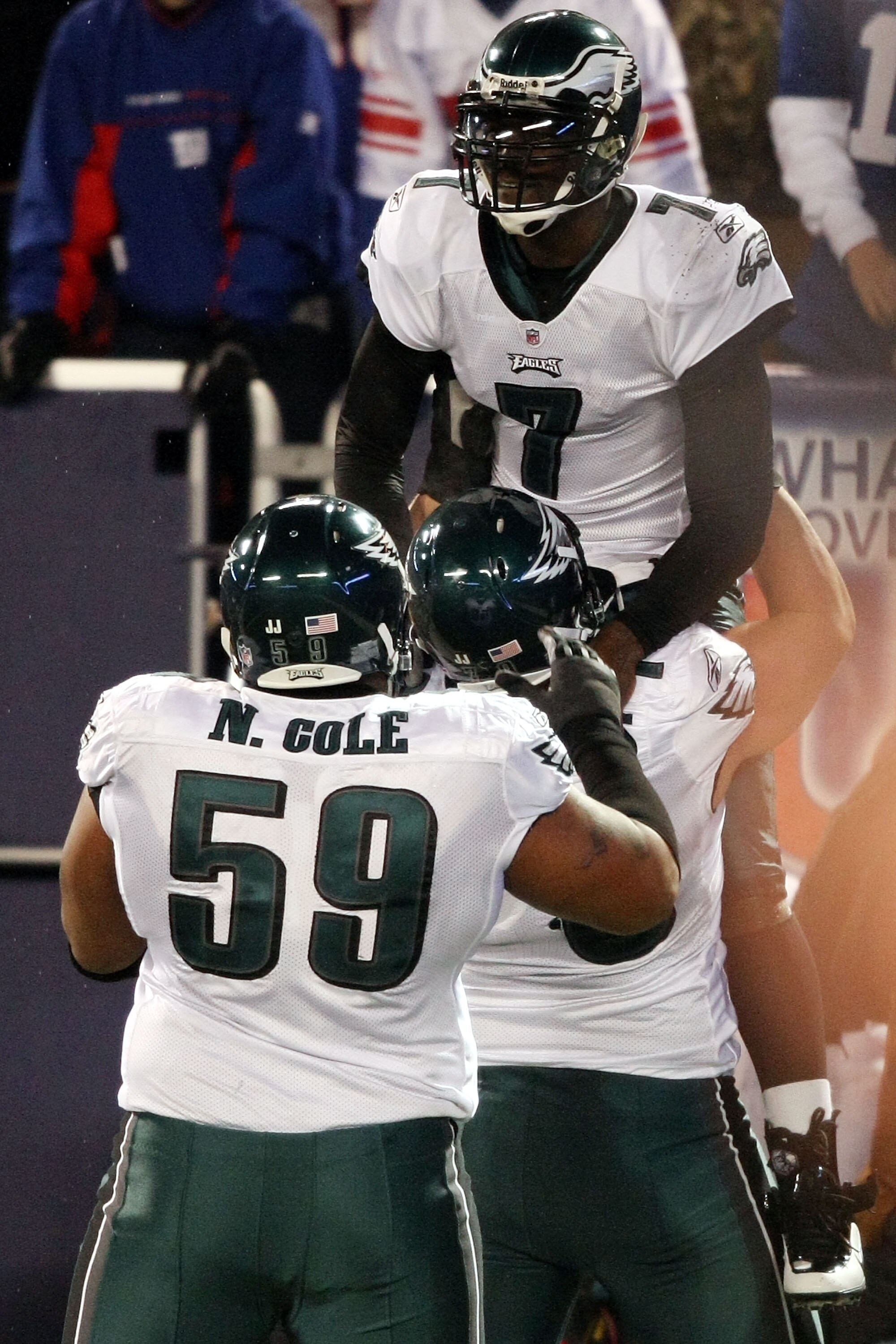 EAST RUTHERFORD, NJ - DECEMBER 13:  Michael Vick #7 of the Philadelphia Eagles celebrates after scoring a touchdown in the second quater with Todd Herremans #79 and Nick Cole #59 against the New York Giants at Giants Stadium on December 13, 2009 in East R