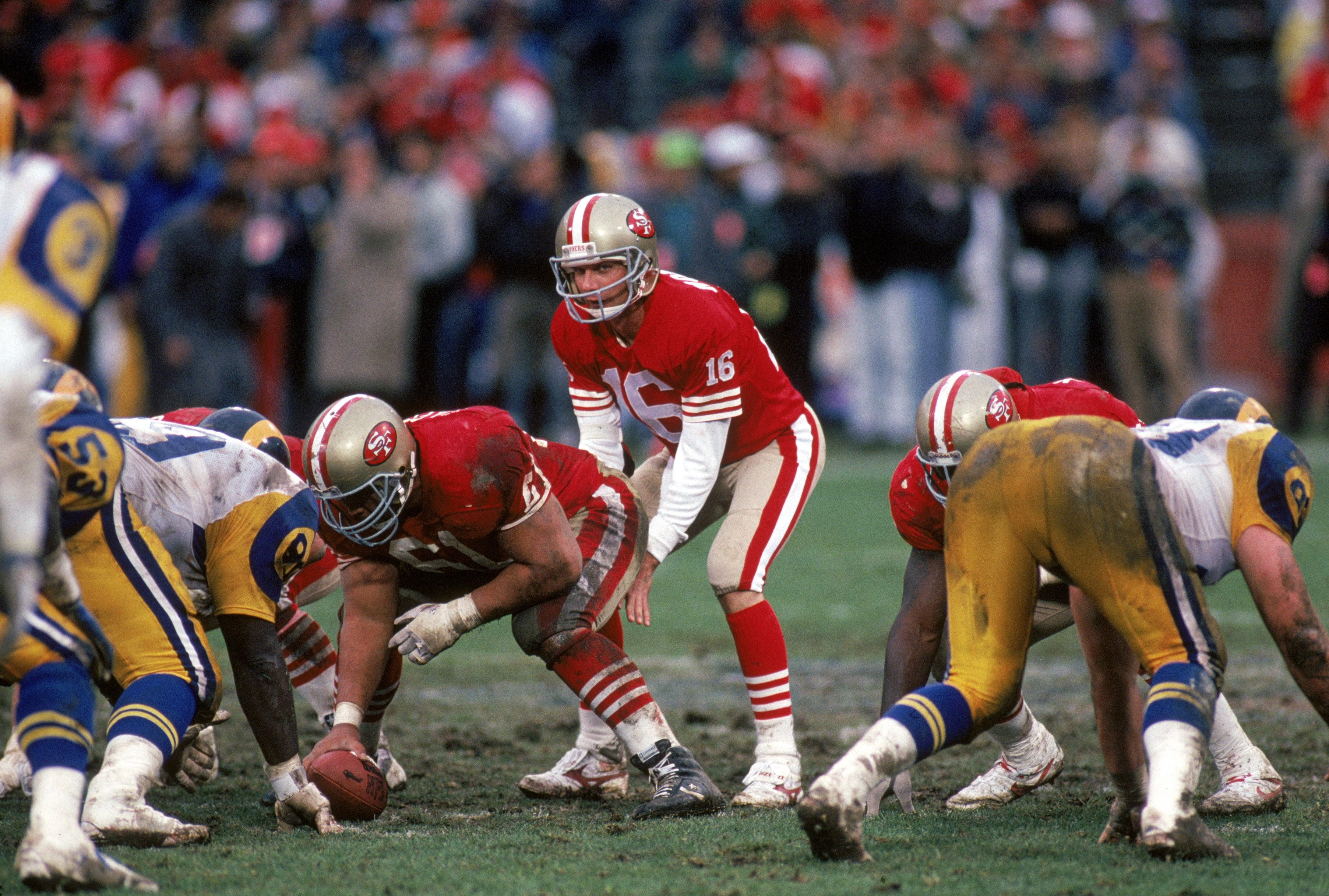 SAN FRANCISCO - JANUARY 14:  Quarterback Joe Montana #16 of the San Francisco 49ers calls for the ball behind center Jesse Sapolu #61 during the NFC Championship game against the Los Angeles Rams at Candlestick Park on January 14, 1990 in San Francisco, C