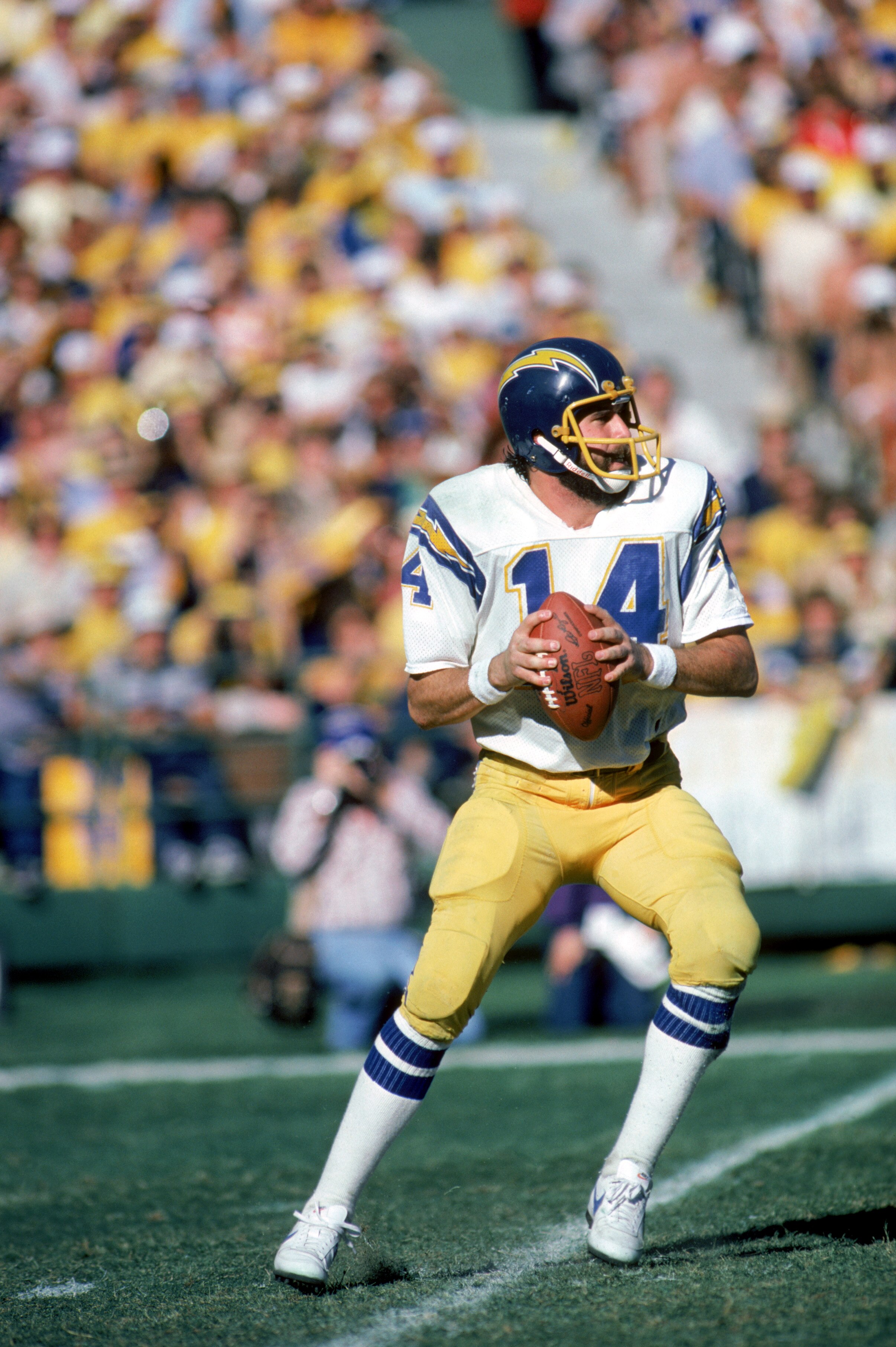 SAN DIEGO -1980: Quarterbck Dan Fouts #14 of the San Diego Chargers looks to pass during a playoff game against the Miami Dolphins at Joe Robbie Stadium in Miami, Florida. The Chargers won the game, 41-38. (Photo by Getty Images)