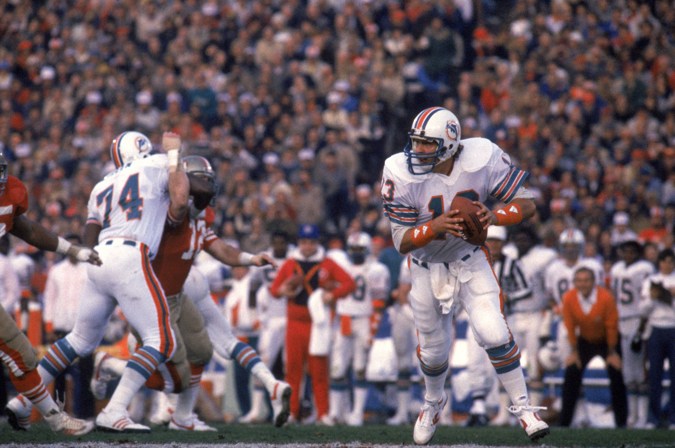 STANFORD, CA - JANUARY 20:  Quarterback Dan Marino #13 of the Miami Dolphins moves out of the pocket as he looks for a receiver during Super Bowl XIX against the San Francisco 49ers at Stanford Stadium on January 20, 1985 in Stanford, California.  The 49e
