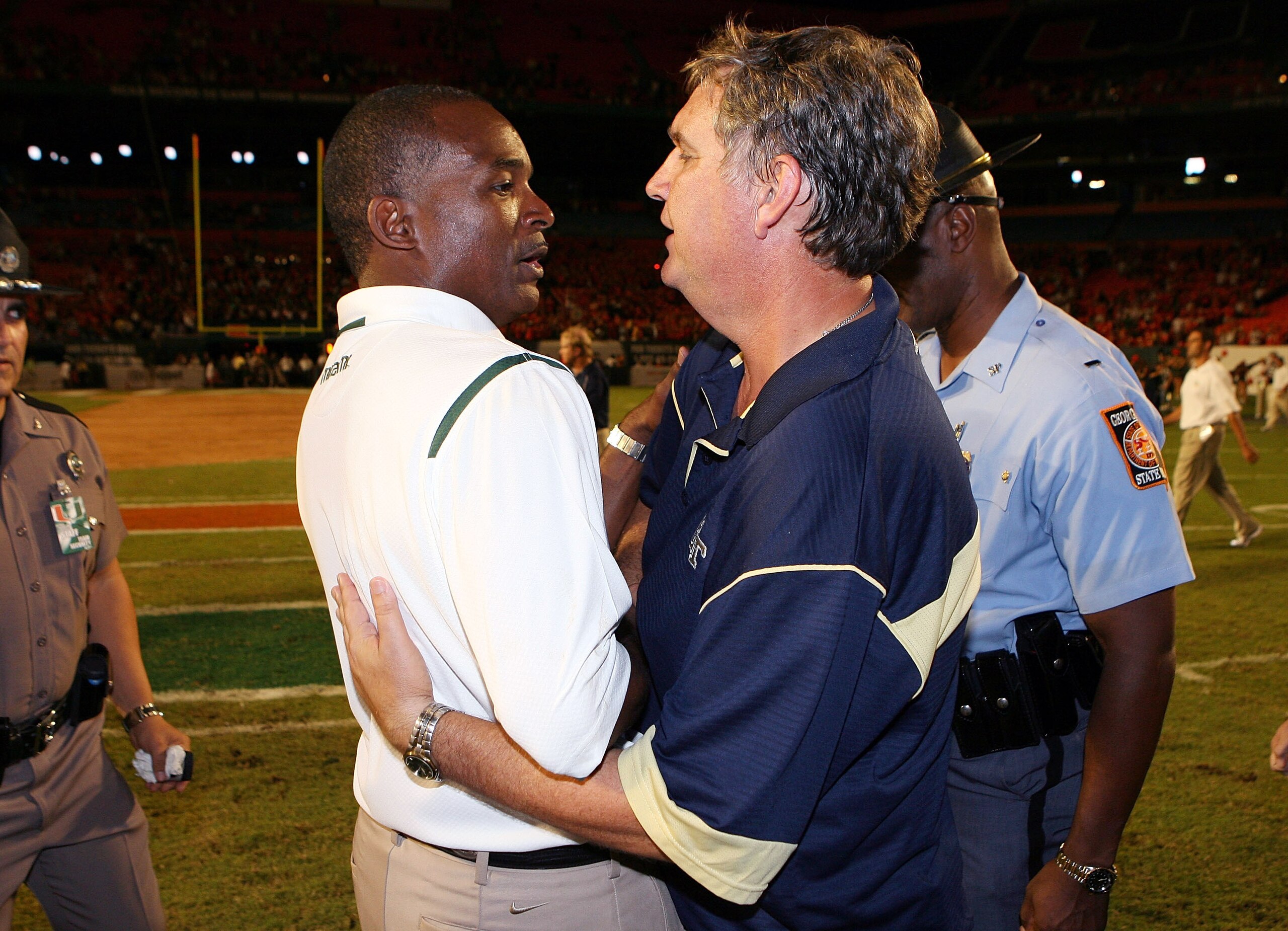 FORT LAUDERDALE, FL - SEPTEMBER 17:  Head coach Paul Johnson, R, of the Georgia Tech Yellow Jackets congratulates head coach Randy Shannon of the Miami Hurricanes at Land Shark Stadium on September 17, 2009 in Fort Lauderdale, Florida. Miami defeated Geor