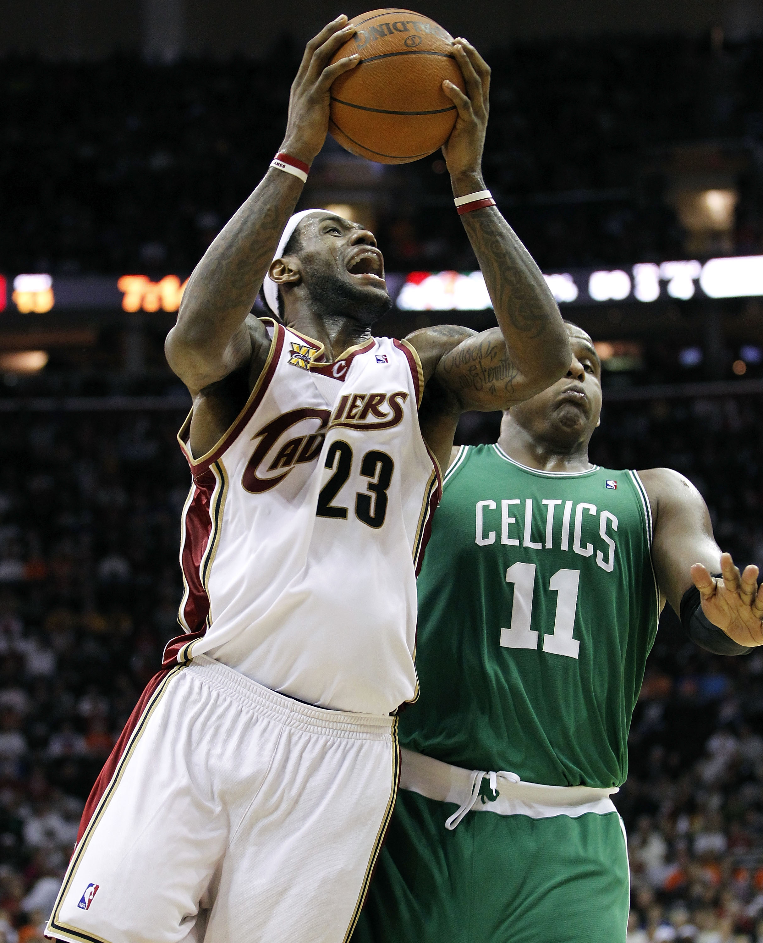 CLEVELAND - MAY 11:  LeBron James #23 of the Cleveland Cavaliers tries to get a shot off around Glen Davis #11 of the Boston Celtics during Game Five of the Eastern Conference Semifinals during the 2010 NBA Playoffs at Quicken Loans Arena on May 11, 2010 