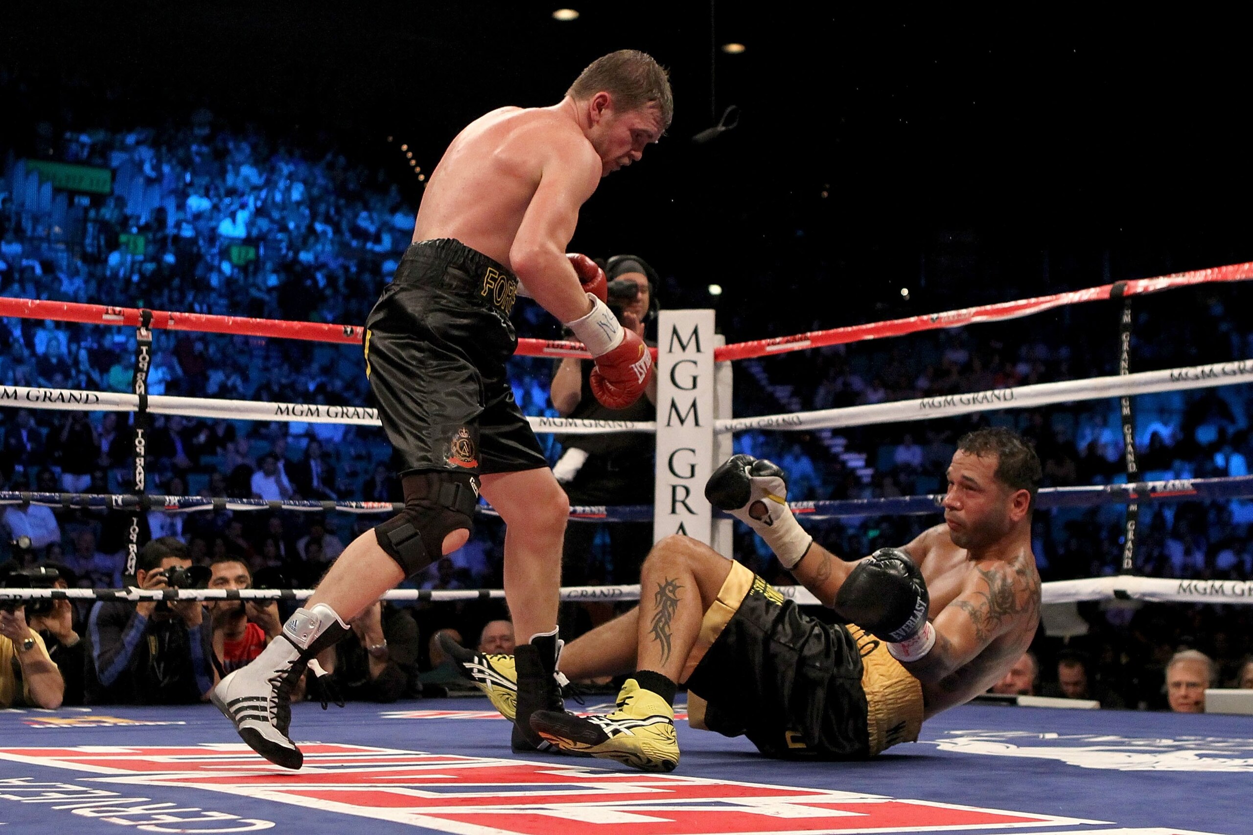 LAS VEGAS - NOVEMBER 14:  (L-R) Yuri Foreman throws a punch as Daniel Santos falls to the mat during their WBA super welterweight title fight at the MGM Grand Garden Arena on November 14, 2009 in Las Vegas, Nevada. Referee Jay Nady ruled Santos went down