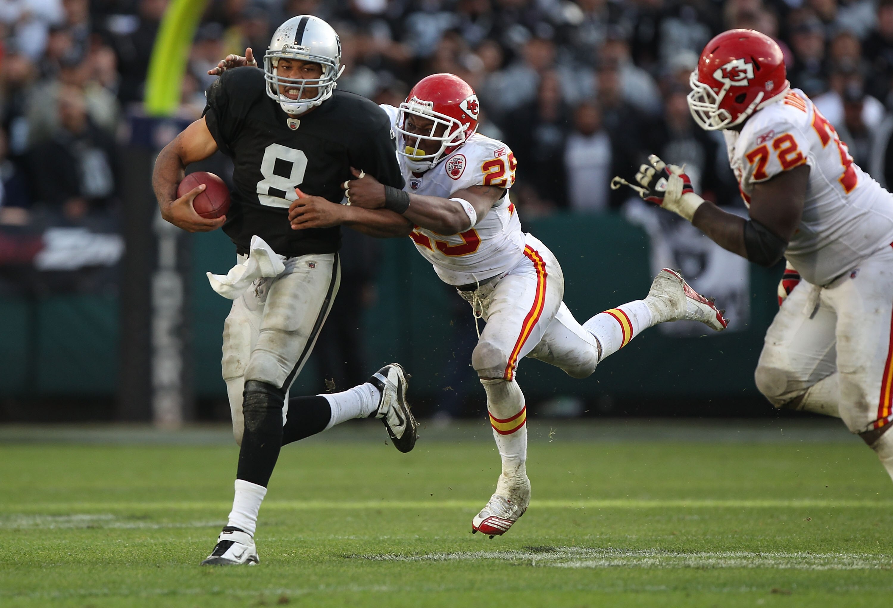 OAKLAND, CA - NOVEMBER 07:  Jason Campbell #8 of the Oakland Raiders runs against Eric Barry #29 of the Kansas City Chiefs during an NFL game at Oakland-Alameda County Coliseum on November 7, 2010 in Oakland, California.  (Photo by Jed Jacobsohn/Getty Ima