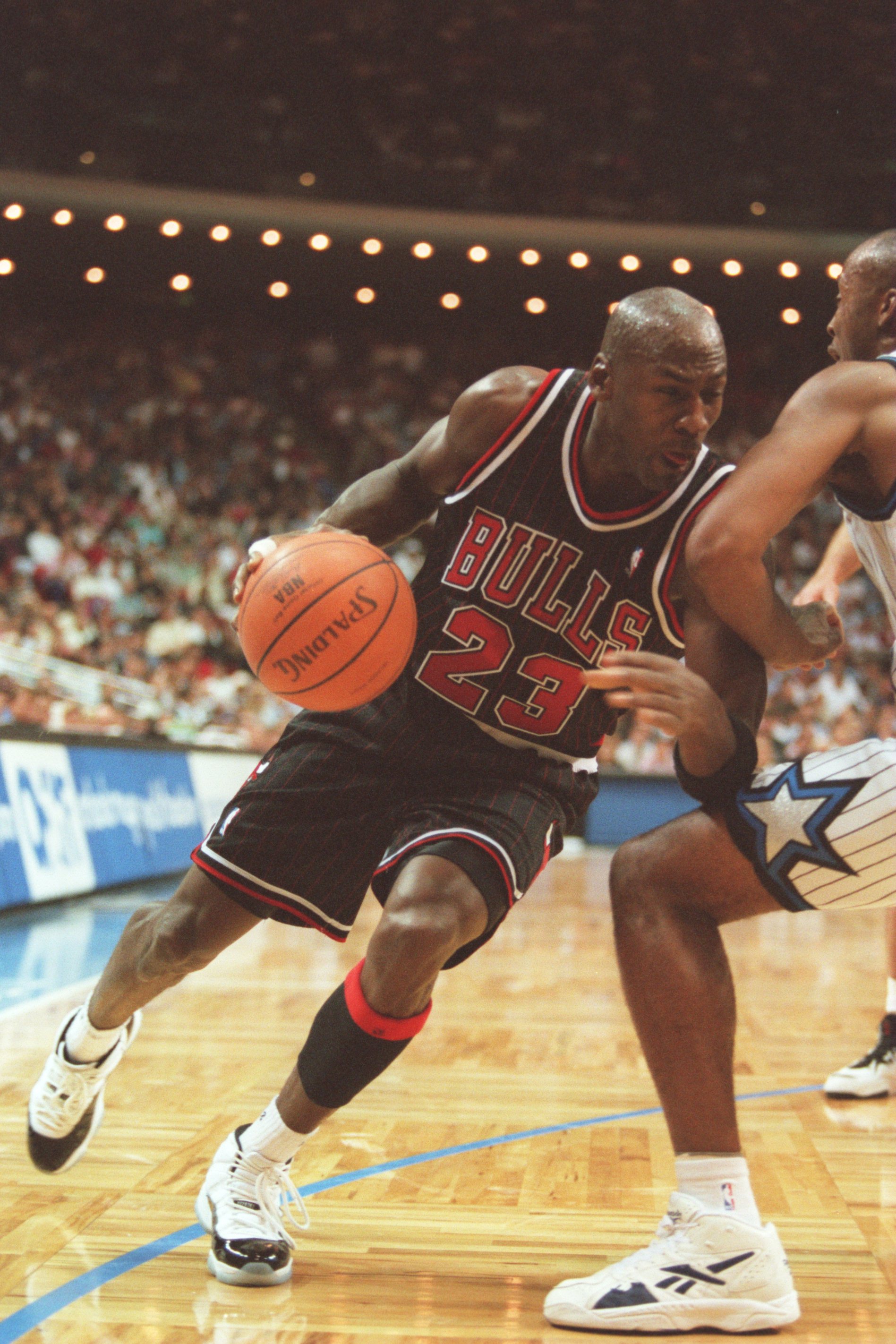 14 Nov 1995:  Guard Michael Jordan #23 of the Chicago Bulls dribbles baseline in an attempt to go around the pressure defense applied by a defender of the Orlando Magic during the Bulls 94-88 loss to the Magic at the Orlando Arena in Orlando, Florida.   M