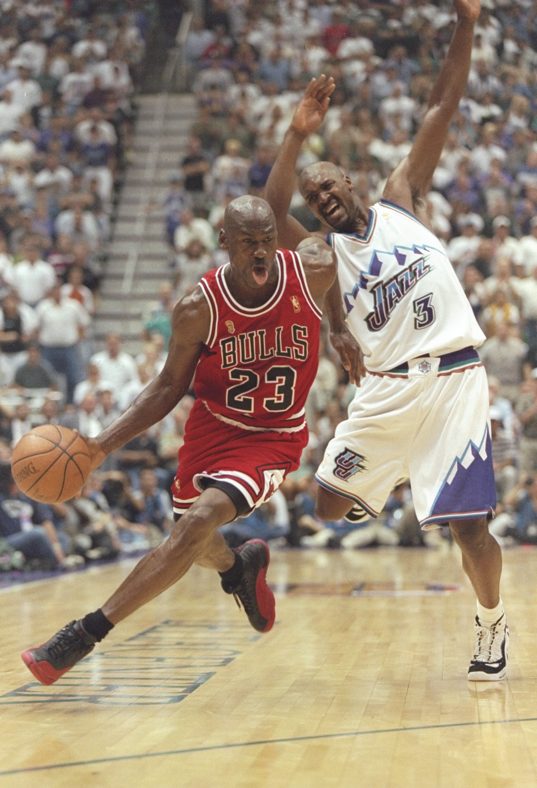11 Jun 1997: Michael Jordan of the Chicago Bulls drives around Bryon Russell #3 of the Jazz during the Bulls 90-88 win over the Utah Jazz in Game 5 of the NBA Finals at the Delta Center in Salt Lake City, Utah.