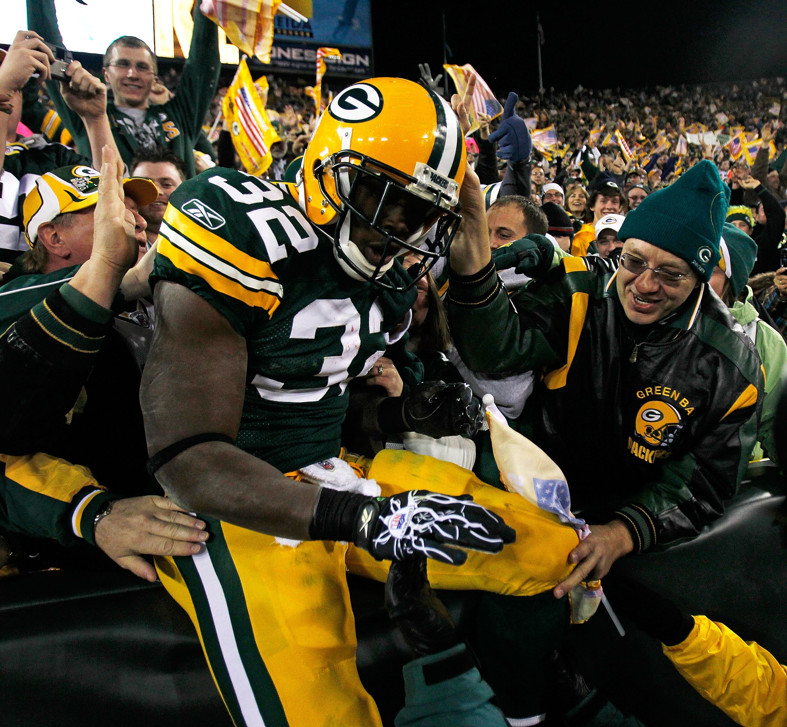 GREEN BAY, WI - NOVEMBER 07: Brandon Jackson #32 of the Green Bay Packers celebrates a touchdown with fans against the Dallas Cowboys at Lambeau Field on November 7, 2010 in Green Bay, Wisconsin. The Packers defeated the Cowboys 45-7.  (Photo by Jonathan 