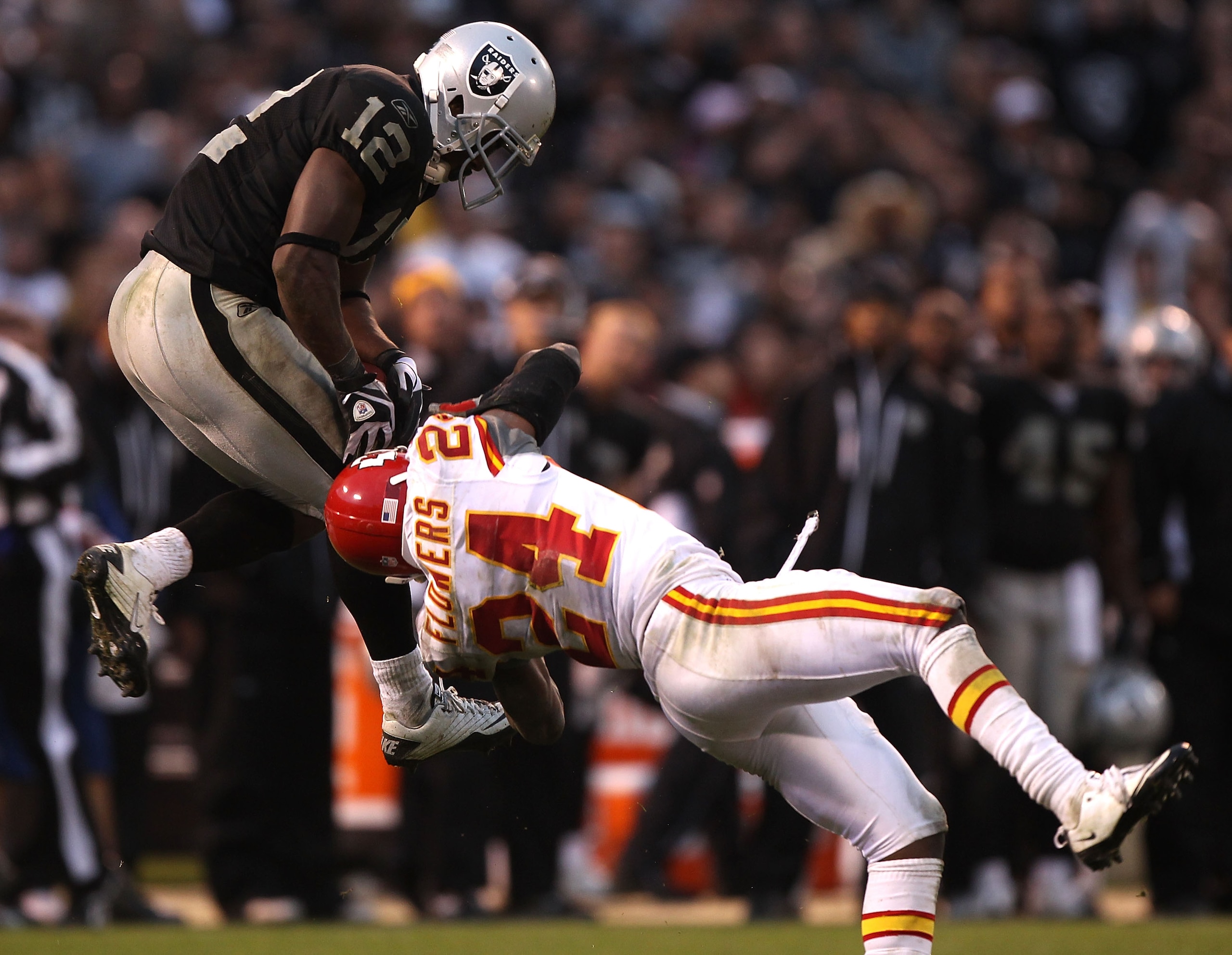 OAKLAND, CA - NOVEMBER 07:  Jacoby Ford #12 of the Oakland Raiders catches a pass over Brandon Flowers #24 of the Kansas City Chiefs during an NFL game at Oakland-Alameda County Coliseum on November 7, 2010 in Oakland, California.  (Photo by Jed Jacobsohn