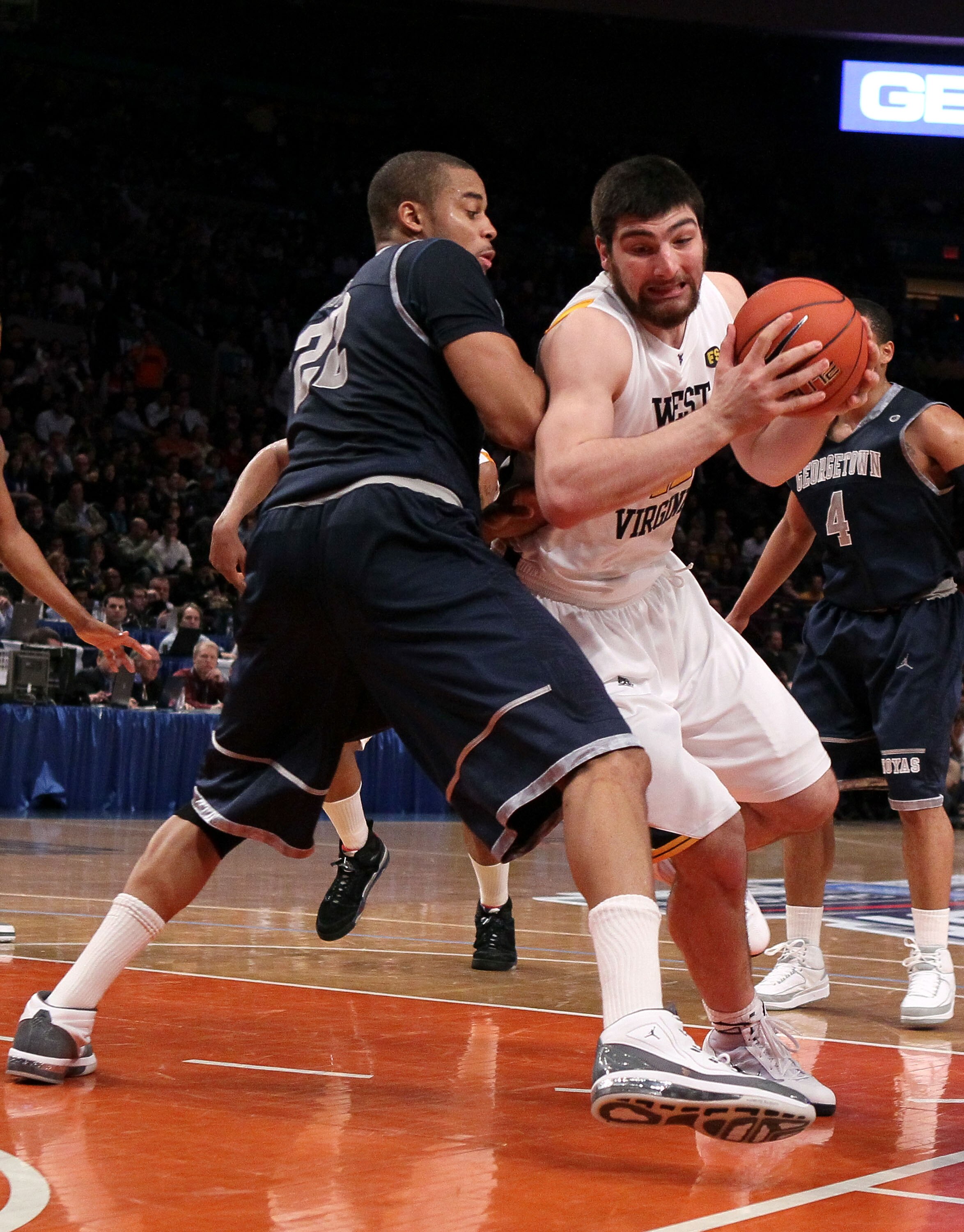 NEW YORK - MARCH 13: Deniz Kilicli #42 of the West Virginia Mountaineers handles the ball against Julian Vaughn #22 of the Georgetown Hoyas during the championship of the 2010 NCAA Big East Tournament at Madison Square Garden on March 13, 2010 in New York