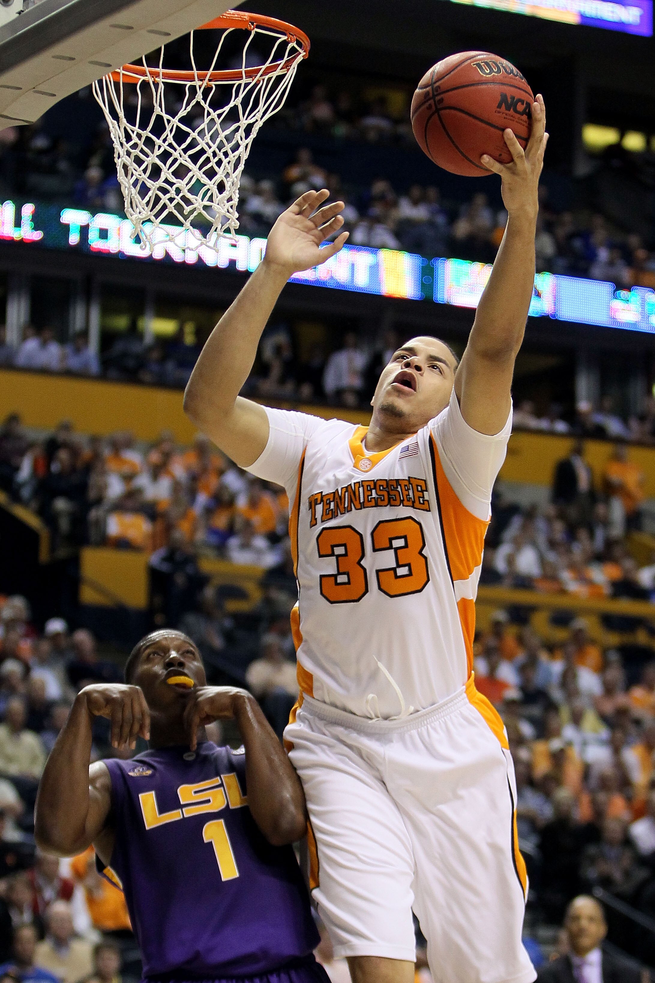 NASHVILLE, TN - MARCH 11:  Brian Williams #33 of the Tennessee Volunteers reaches for a rebound against Tasmin Mitchell #1 of the LSU Tigers during the first round of the SEC Men's Basketball Tournament at the Bridgestone Arena on March 11, 2010 in Nashvi
