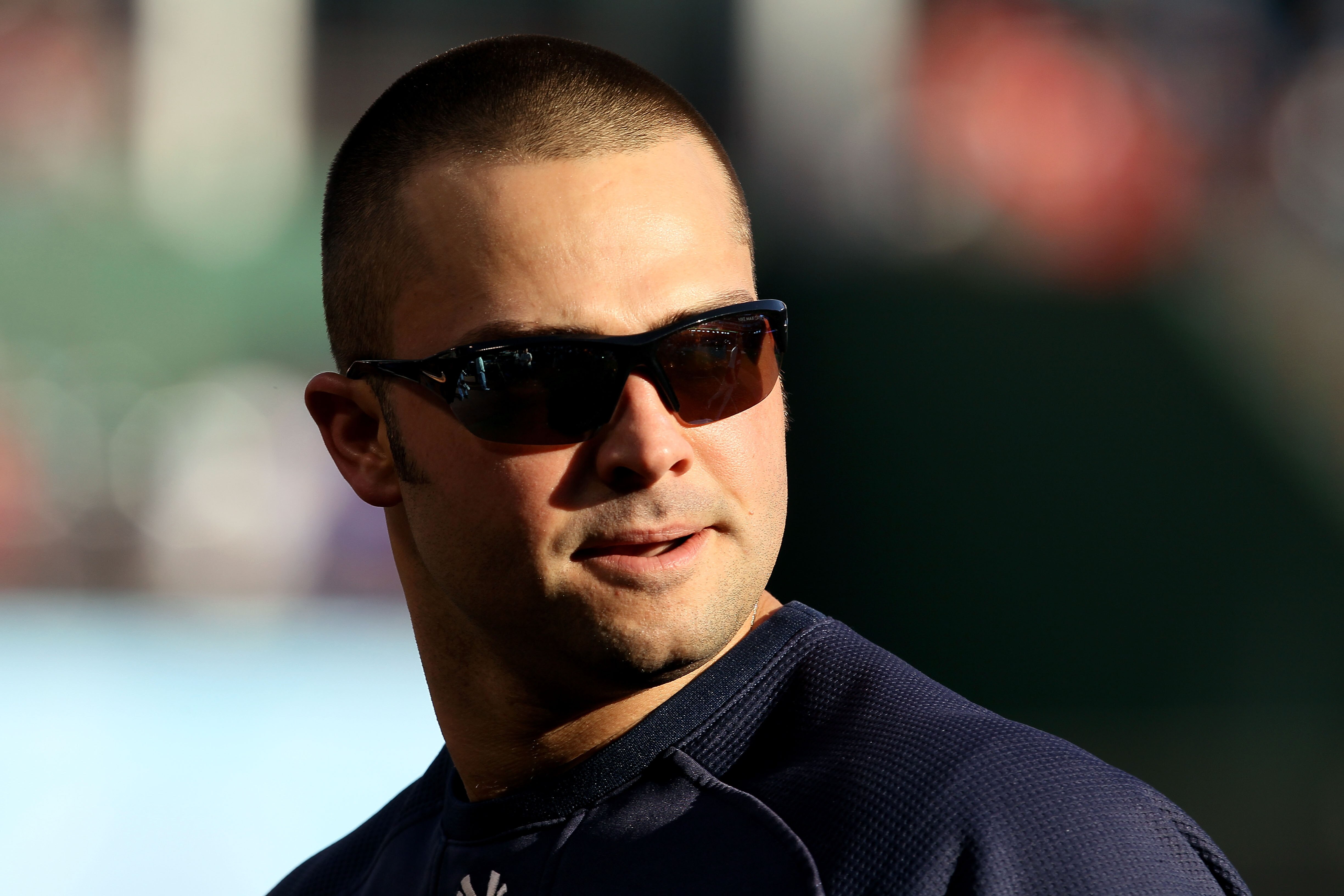 ARLINGTON, TX - OCTOBER 15:  Nick Swisher #33 of the New York Yankees looks on during batting practice against the Texas Rangers in Game One of the ALCS during the 2010 MLB Playoffs at Rangers Ballpark in Arlington on October 15, 2010 in Arlington, Texas.