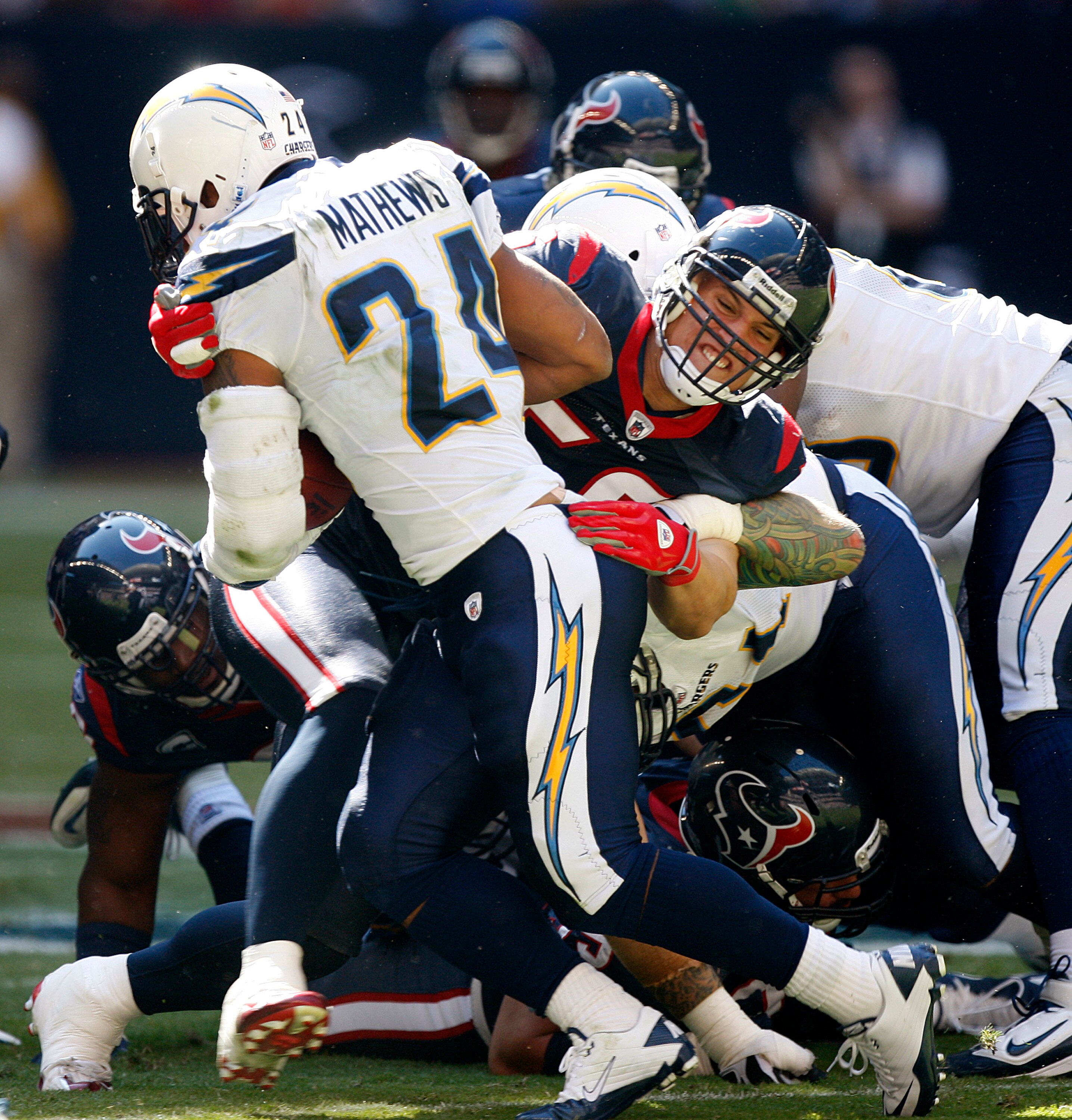 HOUSTON - NOVEMBER 07:  Running back  Ryan Mathews #24 of the San Diego Chargers is tackled by linebacker Brian Cushing #56 of the Houston Texans at Reliant Stadium on November 7, 2010 in Houston, Texas.  (Photo by Bob Levey/Getty Images)