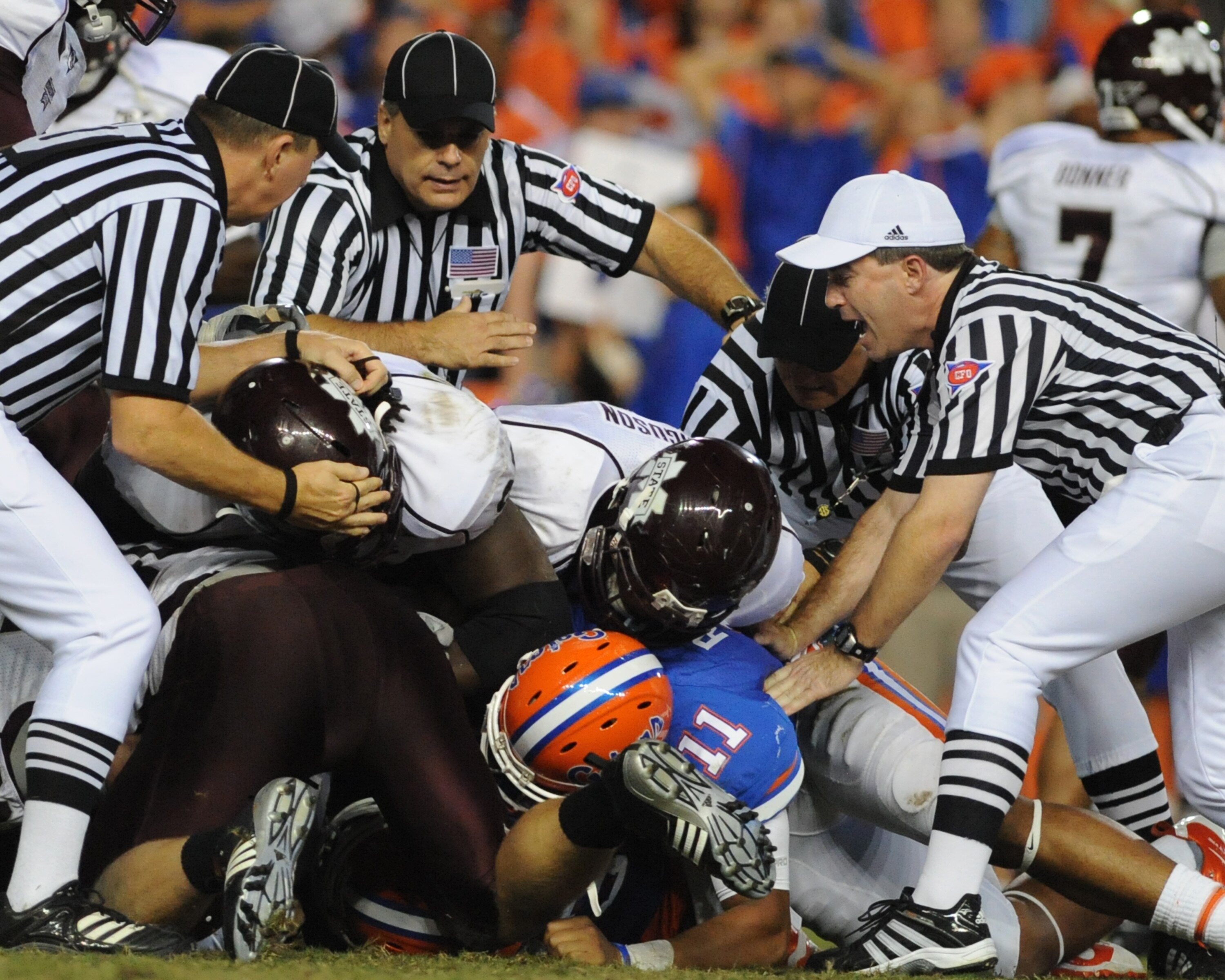 GAINESVILLE, FL - OCTOBER 16:  SEC officials pull players from a fumble pile as the Florida Gators host the Mississippi State Bulldogs October 16, 2010 Ben Hill Griffin Stadium at Gainesville, Florida.  The Bulldogs won 10 - 7. (Photo by Al Messerschmidt/