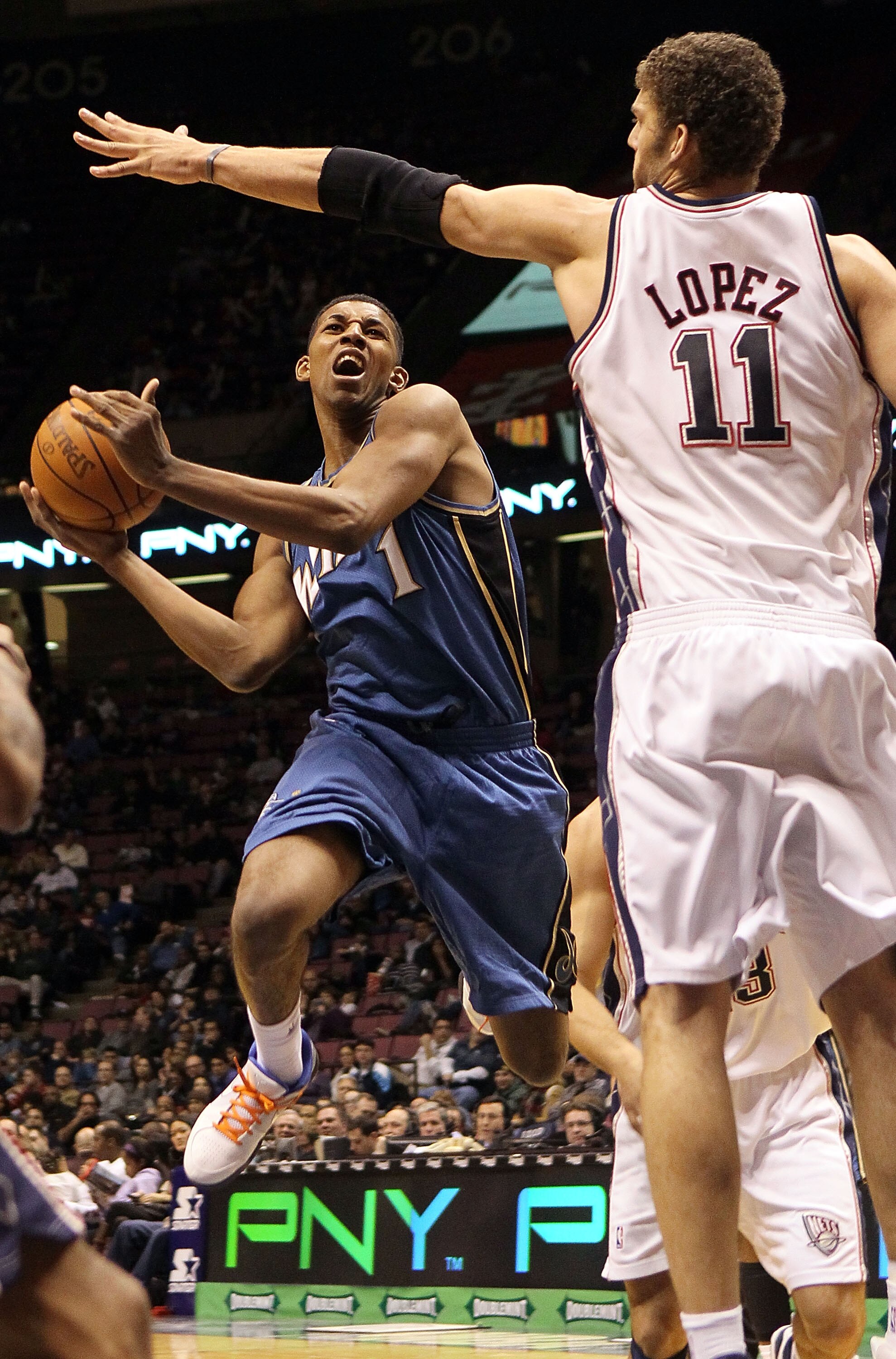 EAST RUTHERFORD, NJ - JANUARY 29:  Nick Young #1 of the Washington Wizards goes to the hoop against Brook Lopez #11 of the New Jersey Nets at the Izod Center on January 29, 2010 in East Rutherford, New Jersey. NOTE TO USER: User expressly acknowledges and