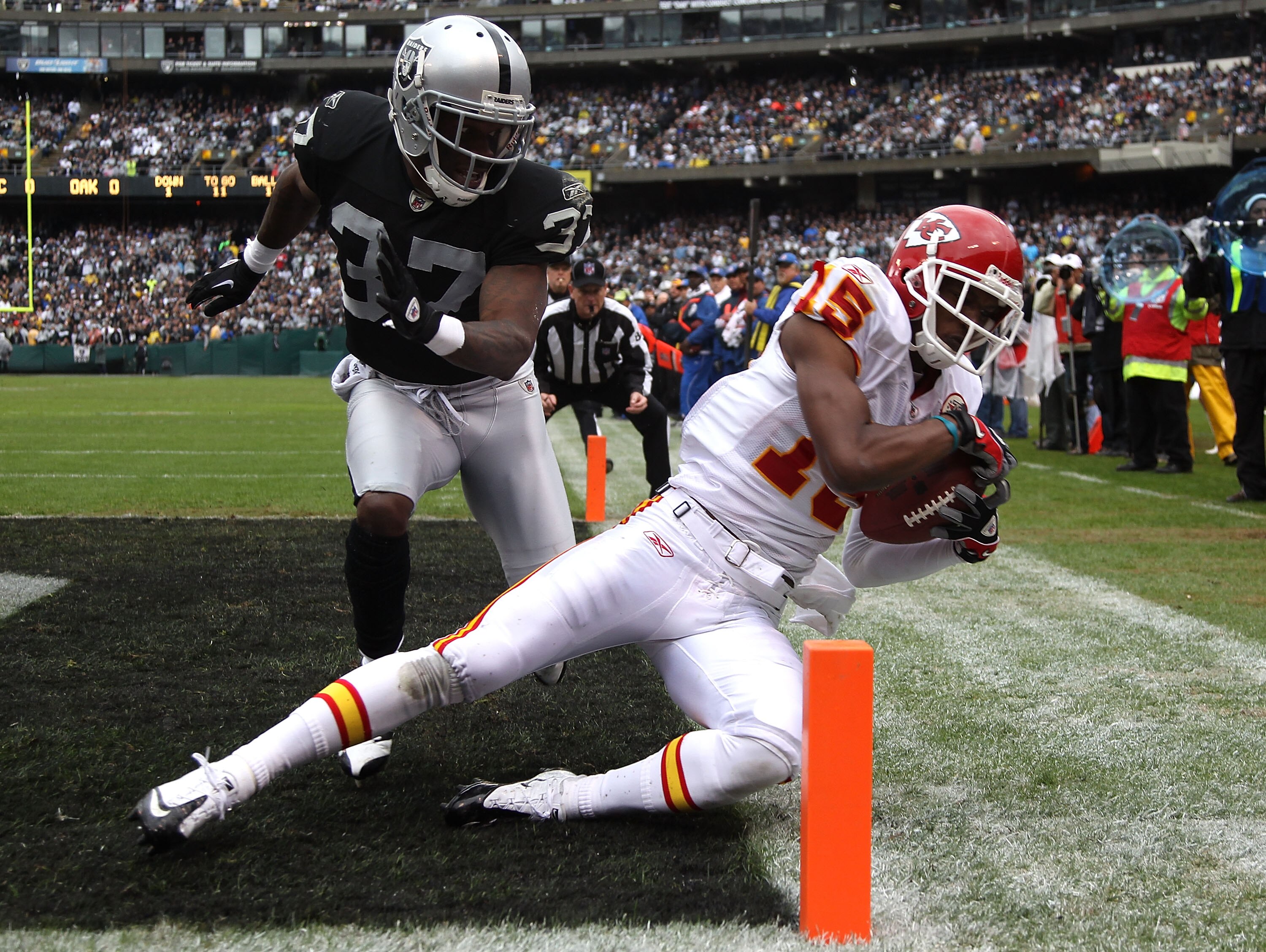 OAKLAND, CA - NOVEMBER 07:  Verran Tucker #15 of the Kansas City Chiefs catches a touchdown pass over Chirs Johnson #37 of the Oakland Raiders during an NFL game at Oakland-Alameda County Coliseum on November 7, 2010 in Oakland, California.  (Photo by Jed